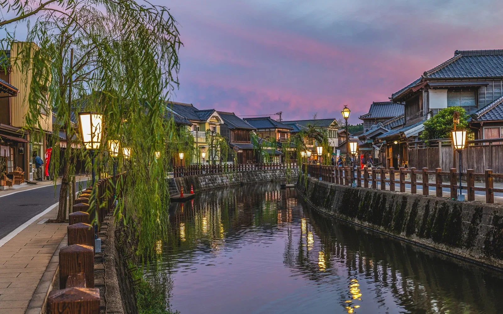 Traditional Japanese village with a river going through the middle of old wooden edo architecture.
