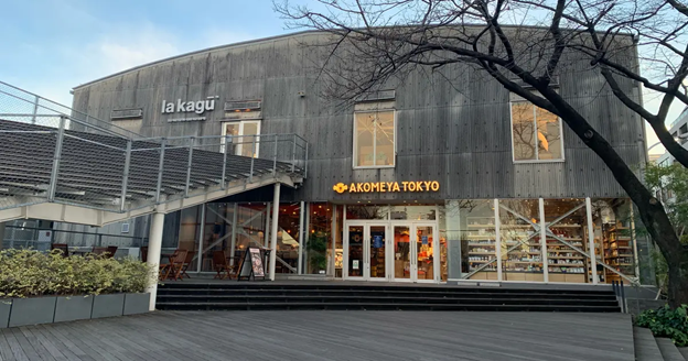 Storefront of Akomeya tokyo with large patio and staircase to sit and enjoy