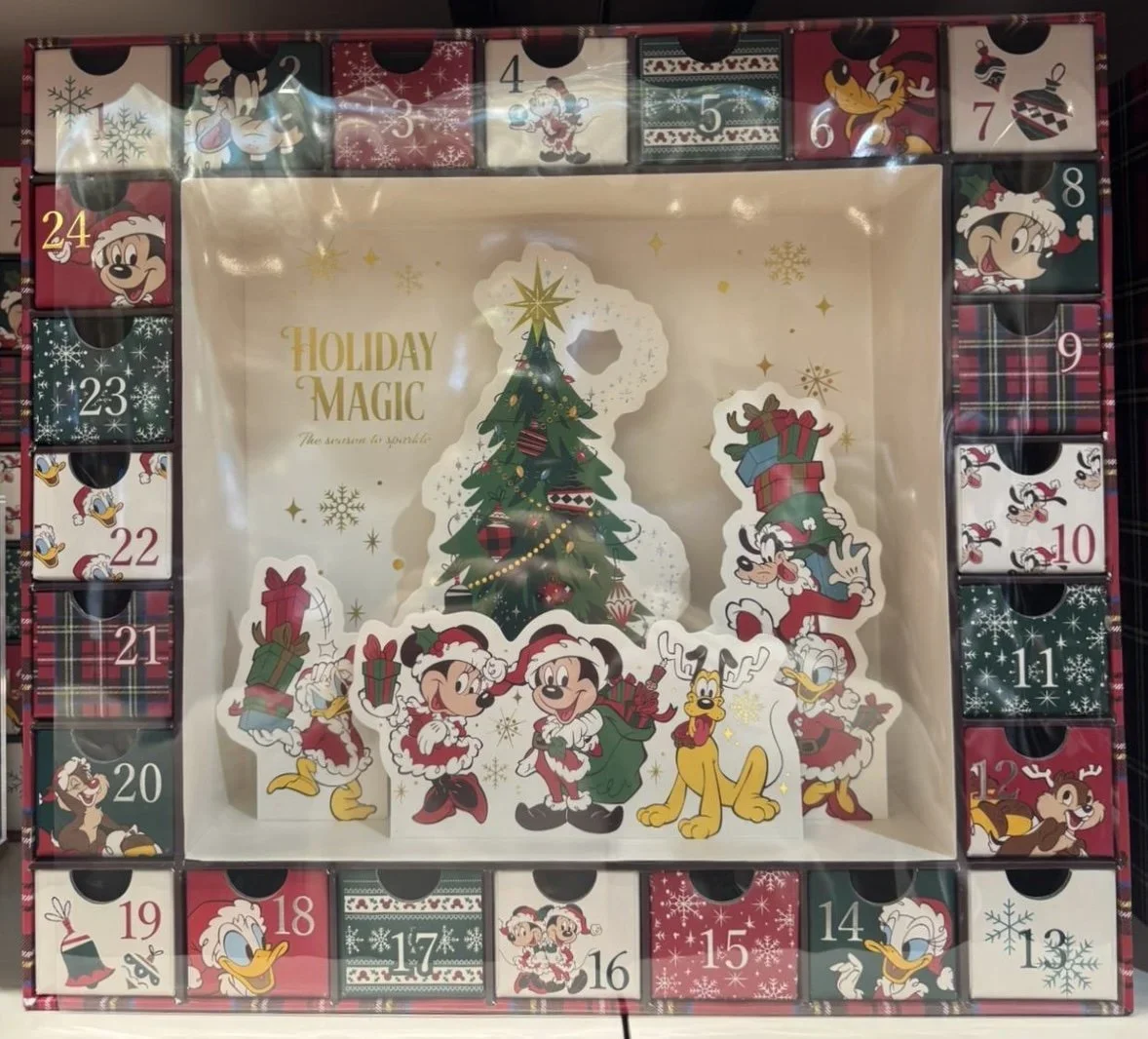 A disney advent calendar with Mickey, Minnie, Pluto, Donald and a Christmas tree.