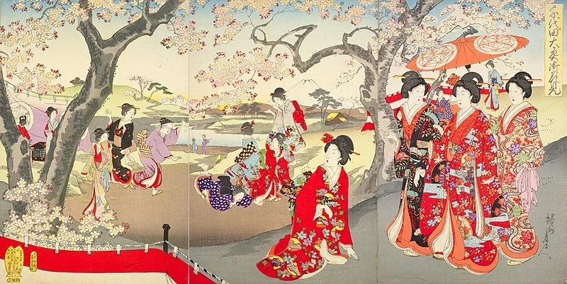 A Japanese Ukioy-e style print featuring friends dressed in a kimono strolling in a park while holding a parasol and viewing the cherry blossoms.