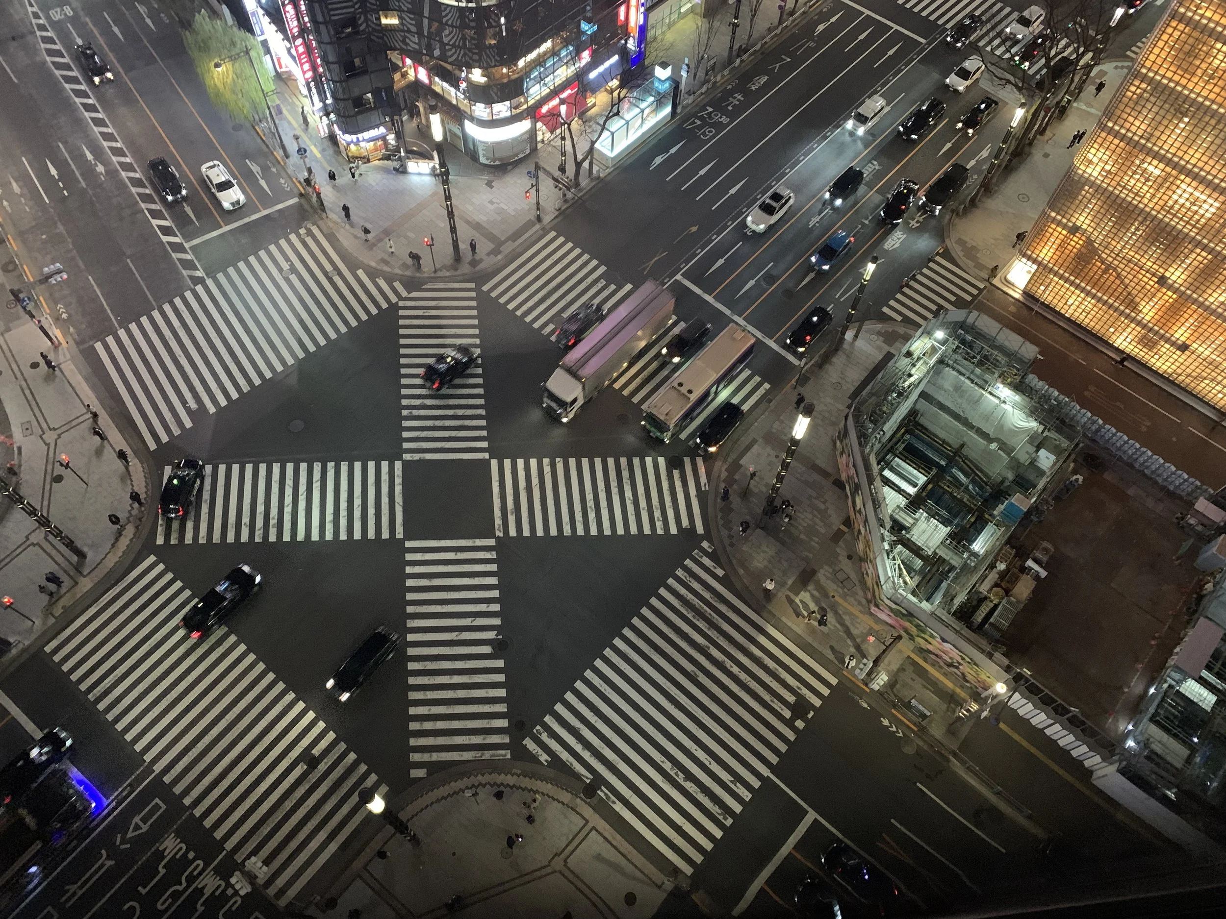 A view from above looking down at an intersection in Ginza with only a few pedestrians.