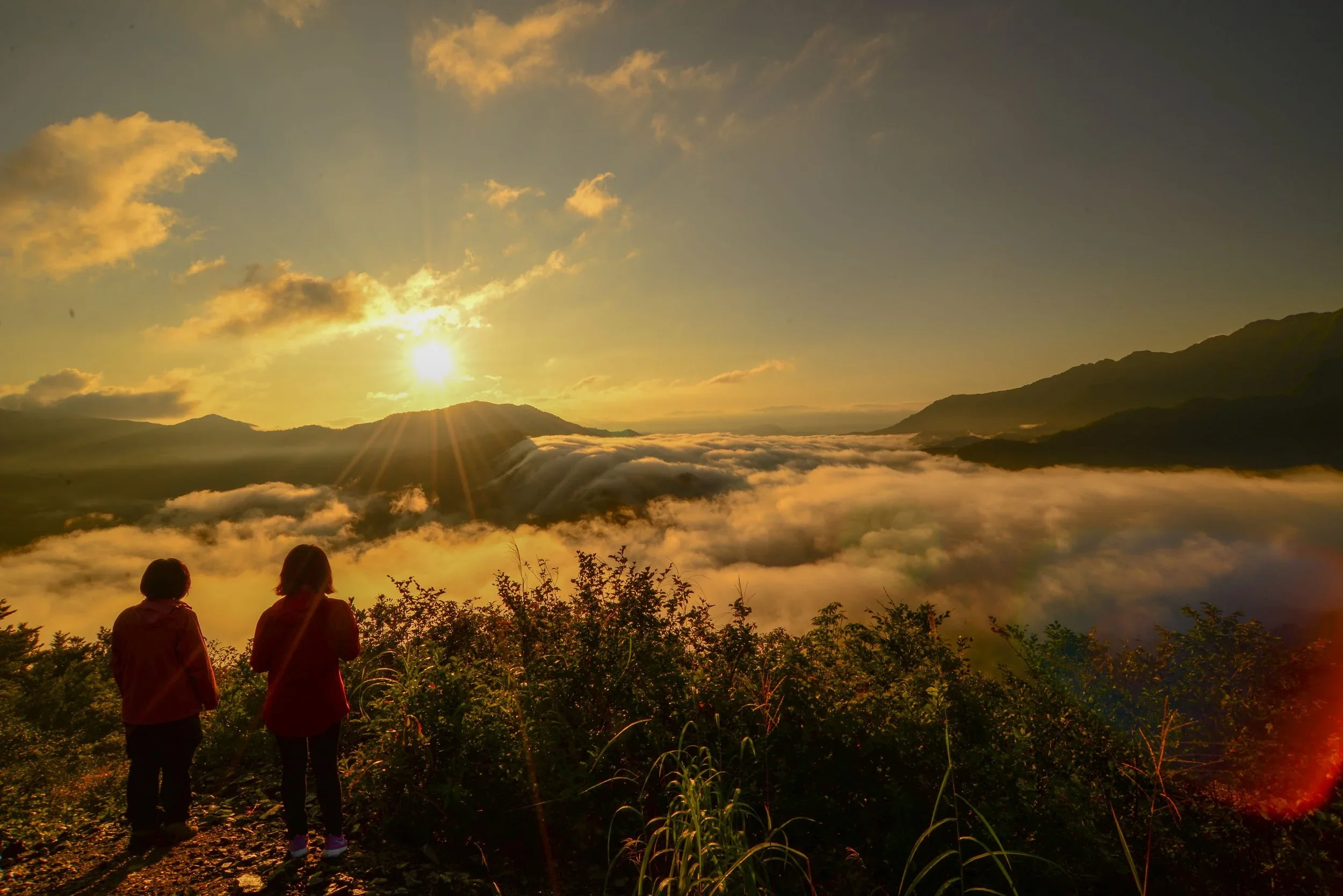 An evening view atop a mountain above the clouds in the fall at golden hour in Tohoku, Japan.
