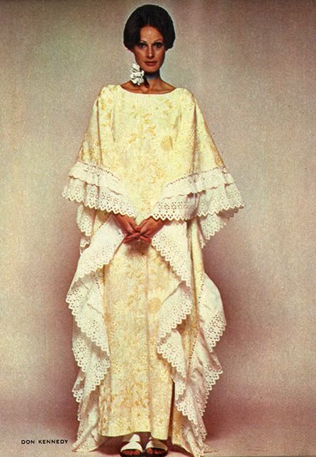Woman wearing a vintage yellow lace dress with layered lace ruffles, standing against a neutral background.