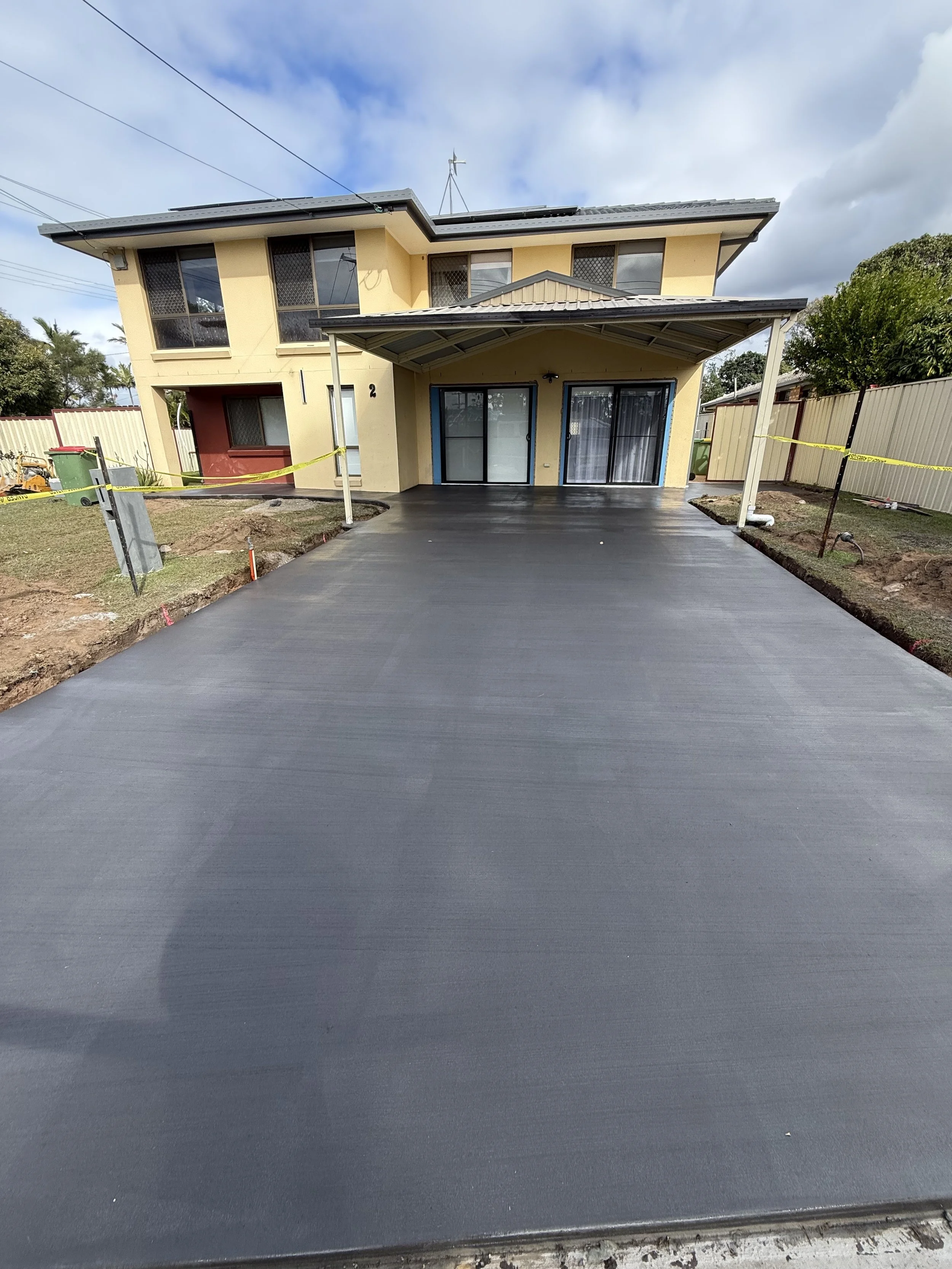coloured concrete driveway poured with Boral Moonlight oxide. New driveway concreted in Brisbane, QLD