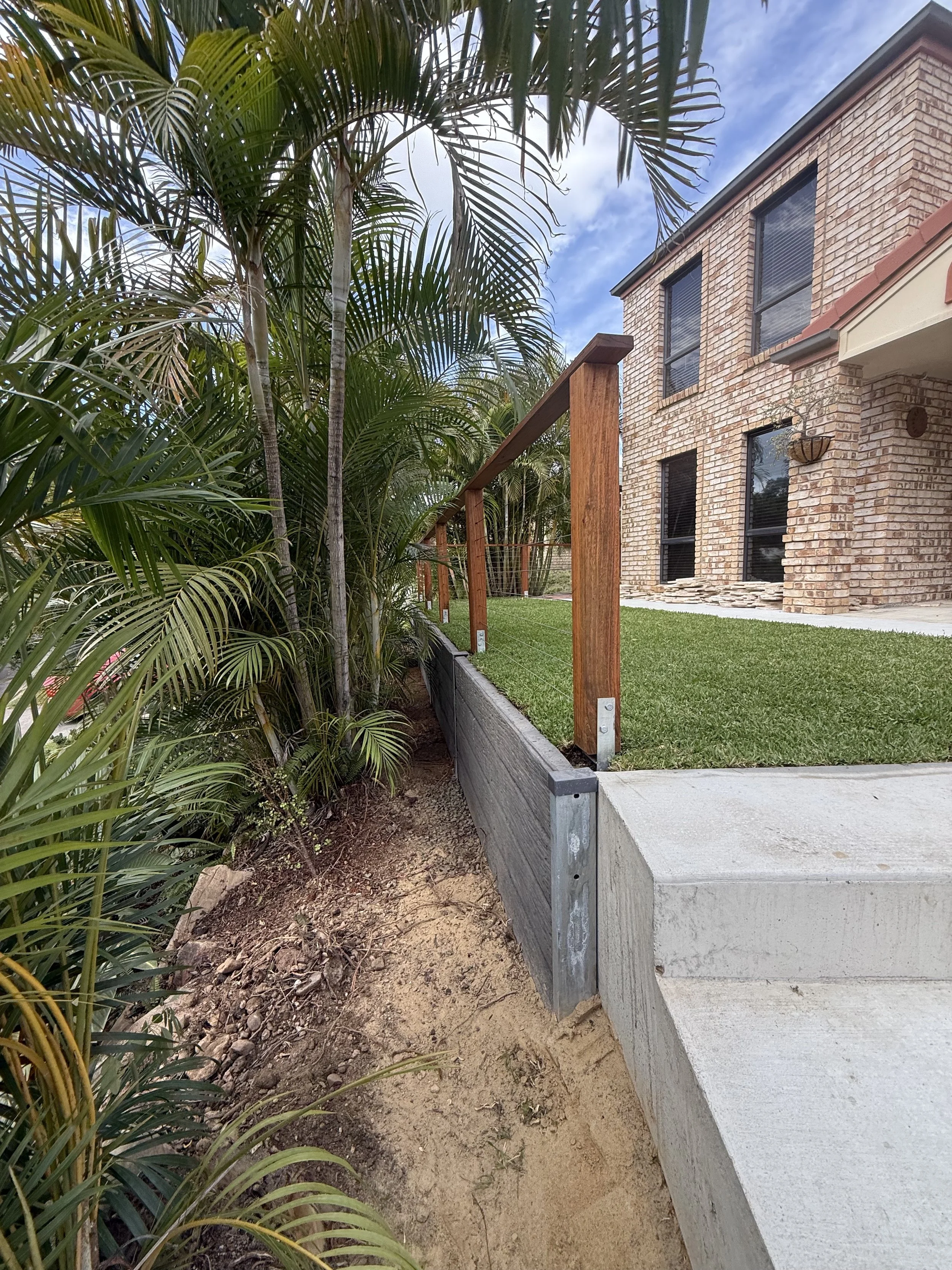 a charcoal concrete sleeper retaining wall built in brisbane qld