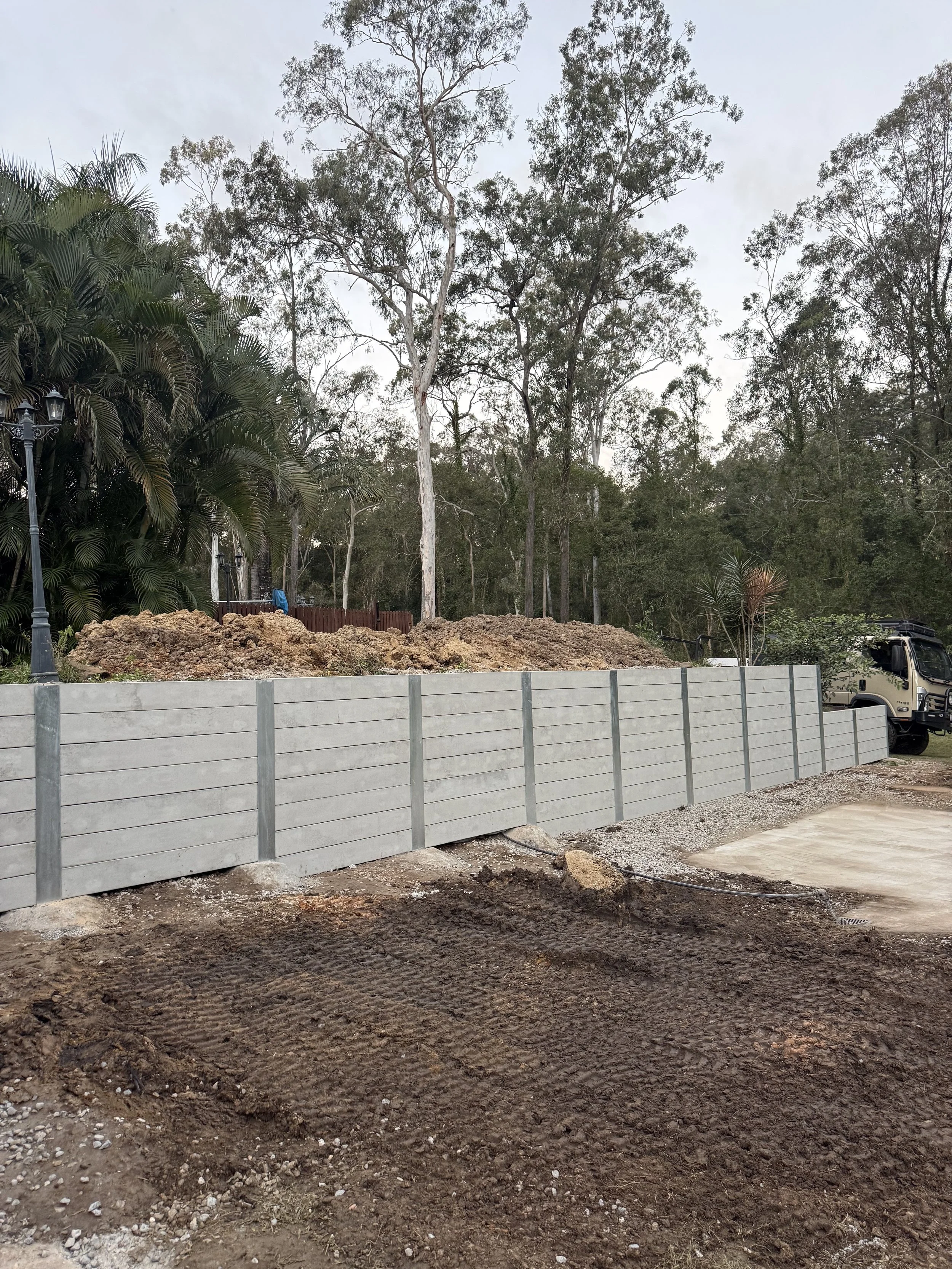 custom concrete sleeper and steel post retaining wall
