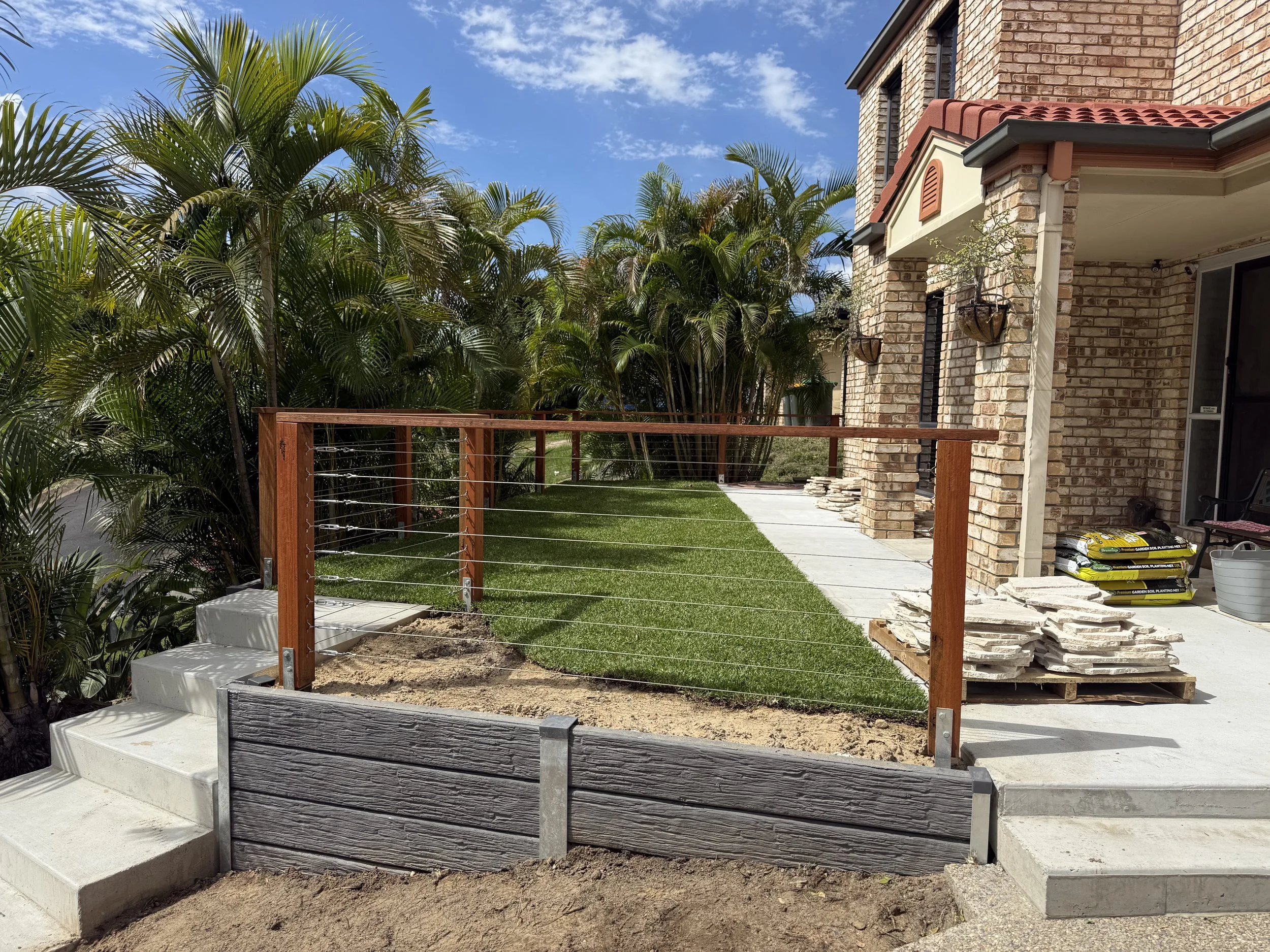 charcoal timber look concrete sleeper retaining wall with steel posts