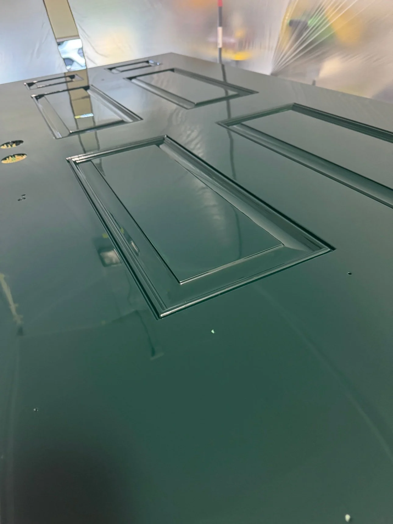 The finished high-gloss door reinstalled with polished brass hardware