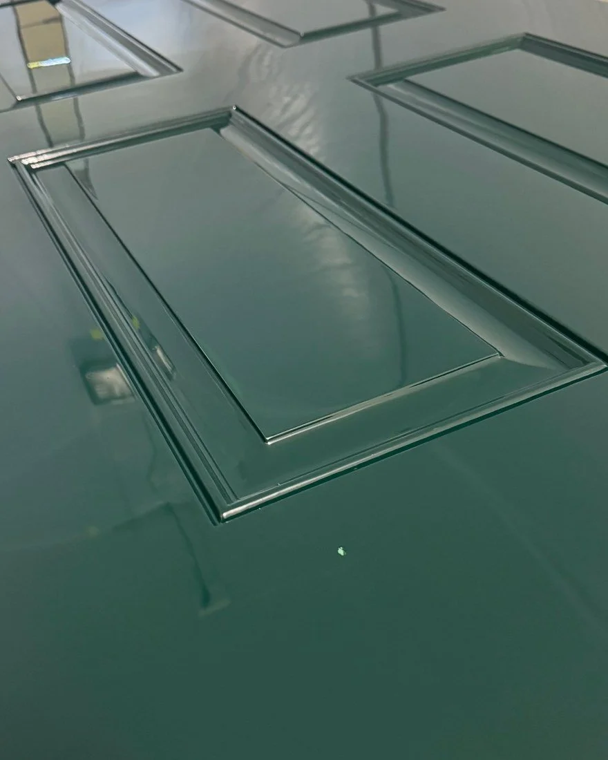 Detail of one raised panel on the door in the booth in deep green high gloss