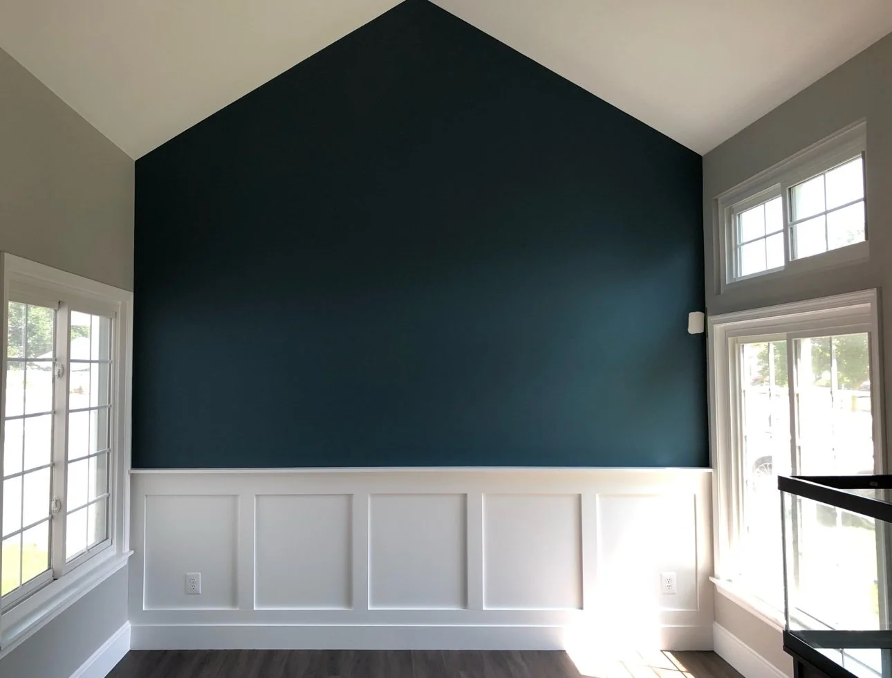 Finished room with a deep teal gable accent wall