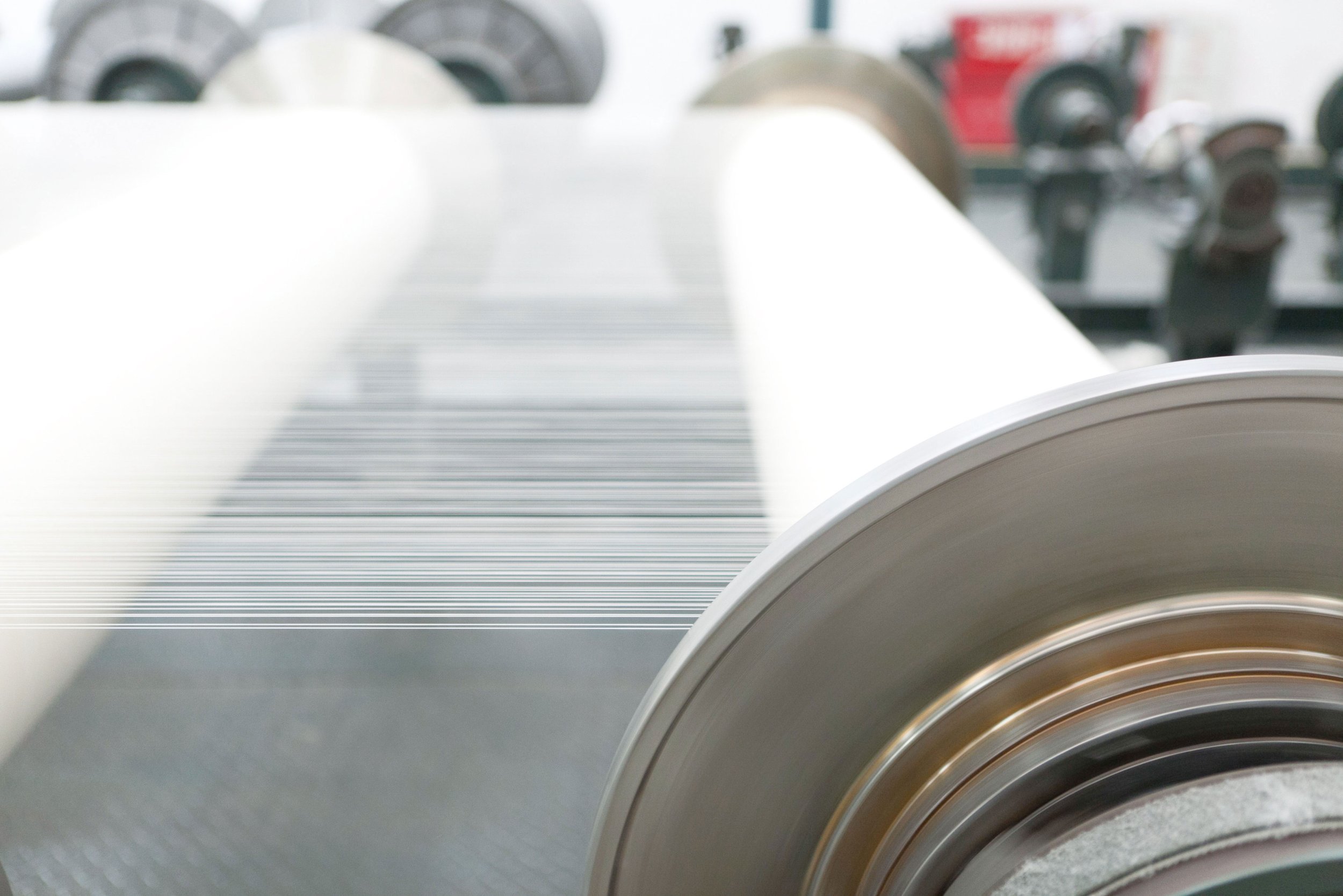 Close-up of a roll of photo film or film strip being unspooled, with the focus on the winding edge and metallic center.
