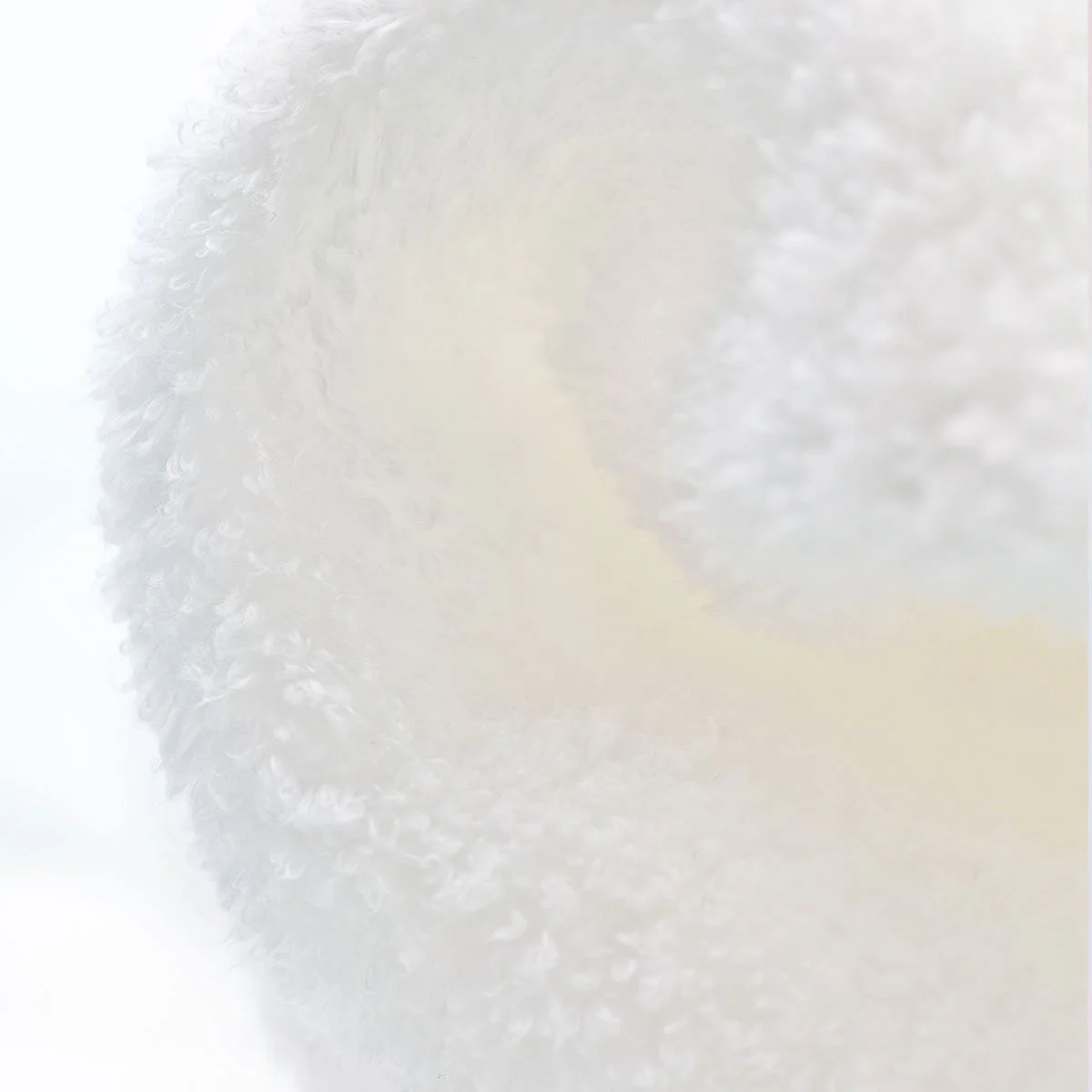 Close-up of a white, textured, and frothy surface.