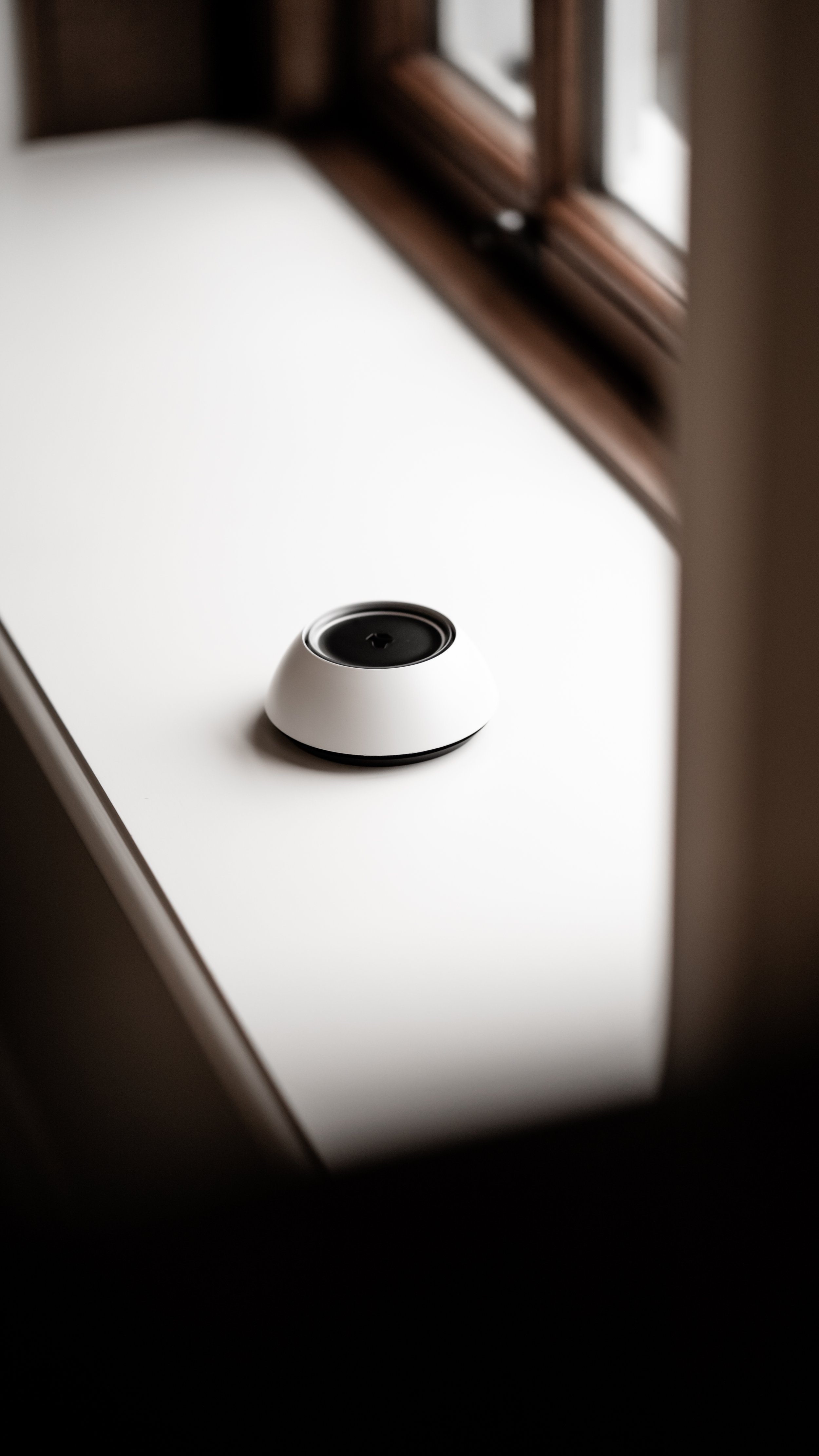 Josh Ai pod in windowsill.  Sleek and simple design helps Josh AI technology blend into your home for seamless finishes .