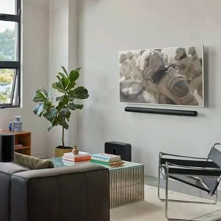 Sonos sound system in luxury apartment living room installed sleek and simple under a TV blending in perfectly with the modern style