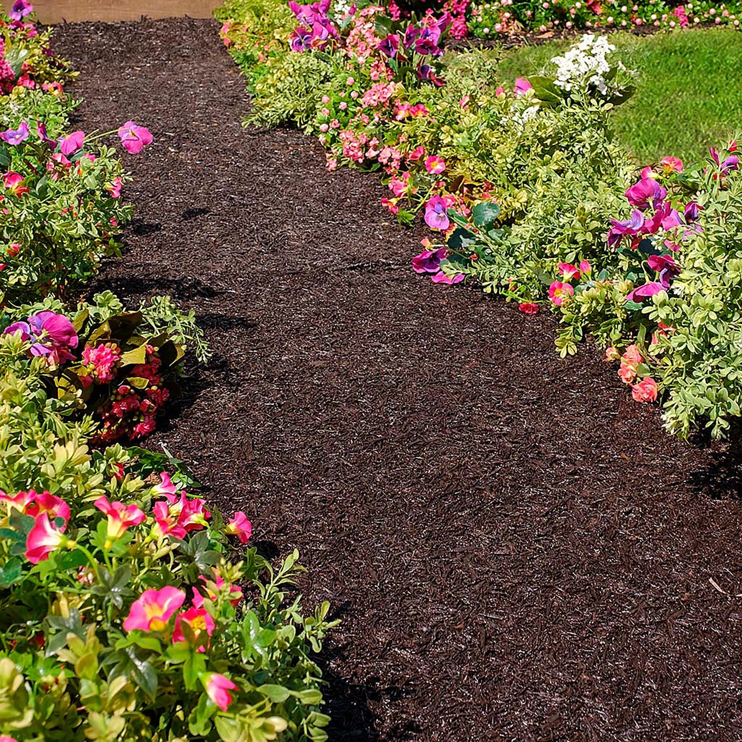 A garden pathway bordered by colorful flowers, including pink, white, and purple blooms, with green grass on the side.