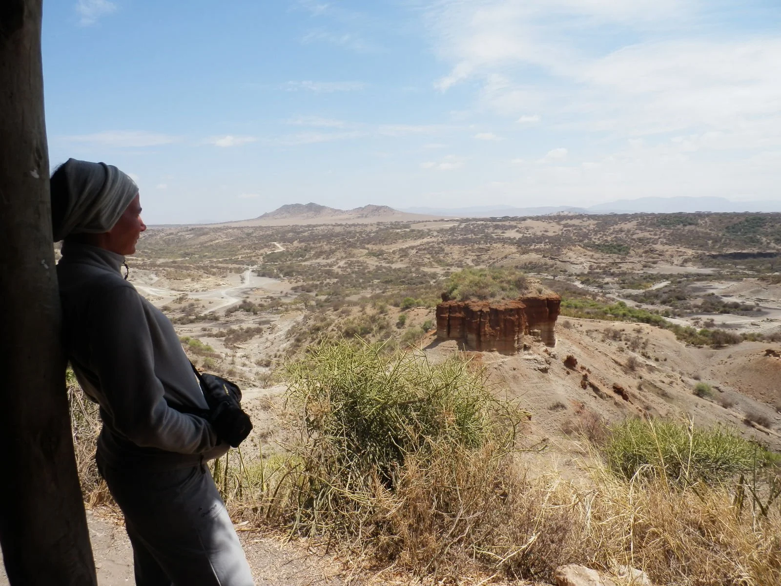 A traveler looking at the archeological site, the Oldupai Gorge, at Ngorongoro Conservation Area, Tanzania
