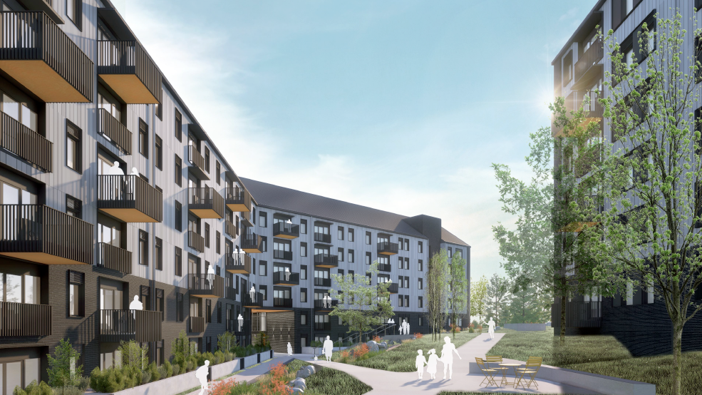 Modern apartment complex with multiple buildings, balconies, landscaping, and people walking and sitting outside.