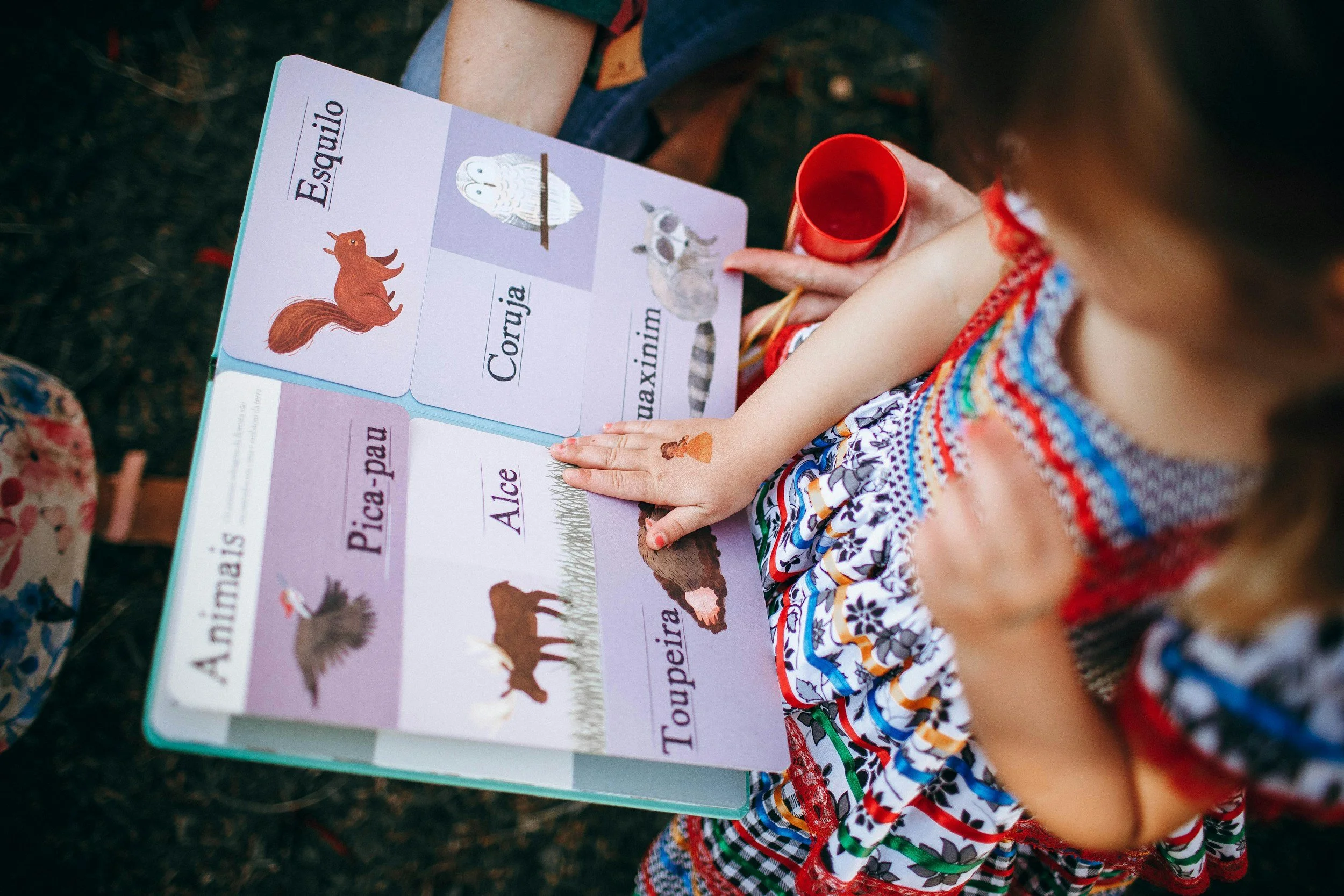 Hands turning pages while reading with a child