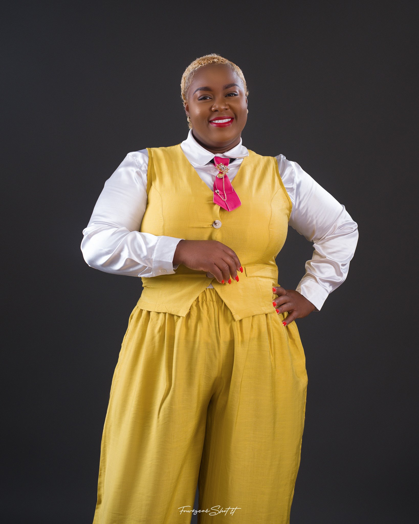 Shemeka Joseph in a gold outfit in a full-length studio portrait