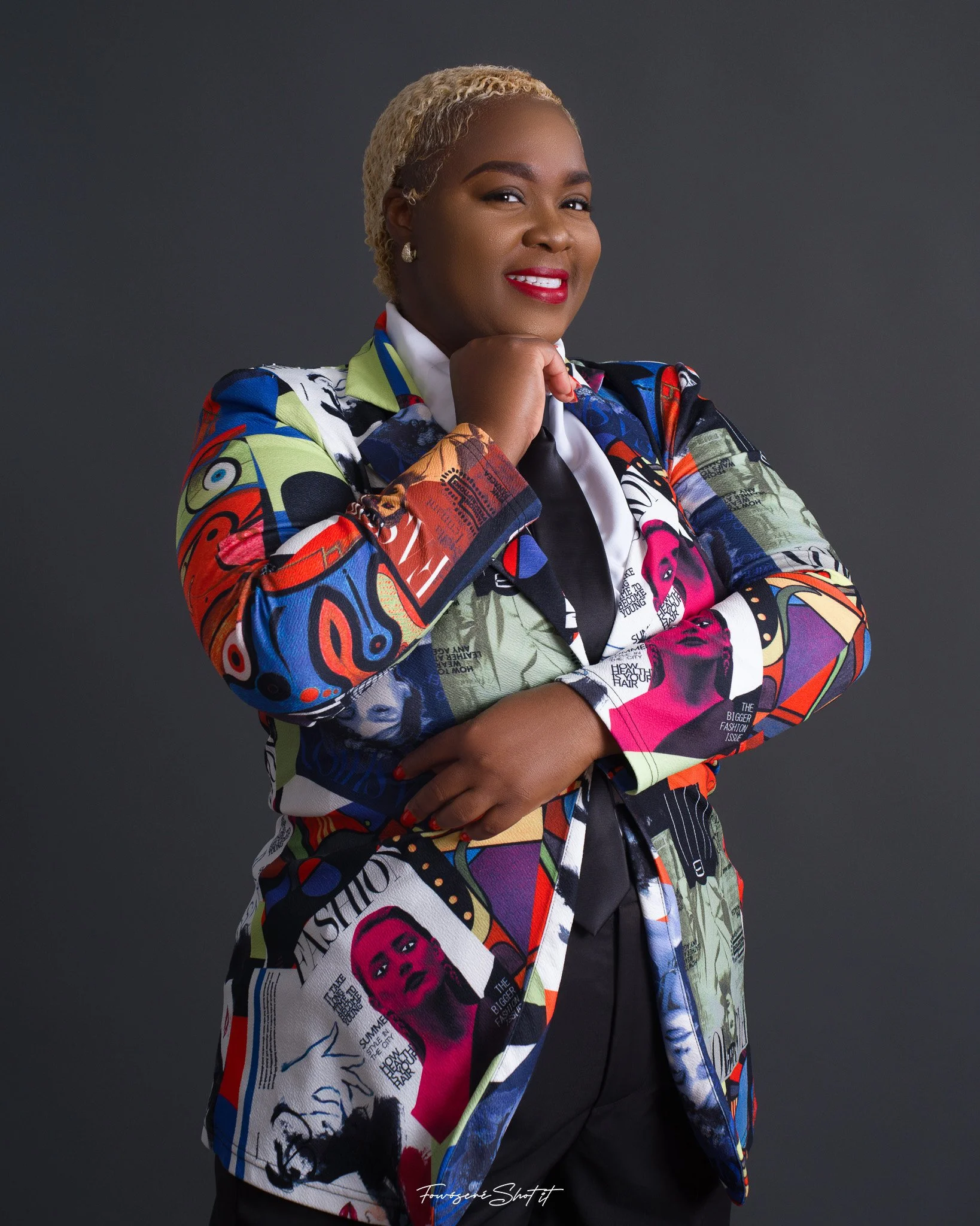 Shemeka Joseph in a colourful blazer, smiling confidently in a studio portrait