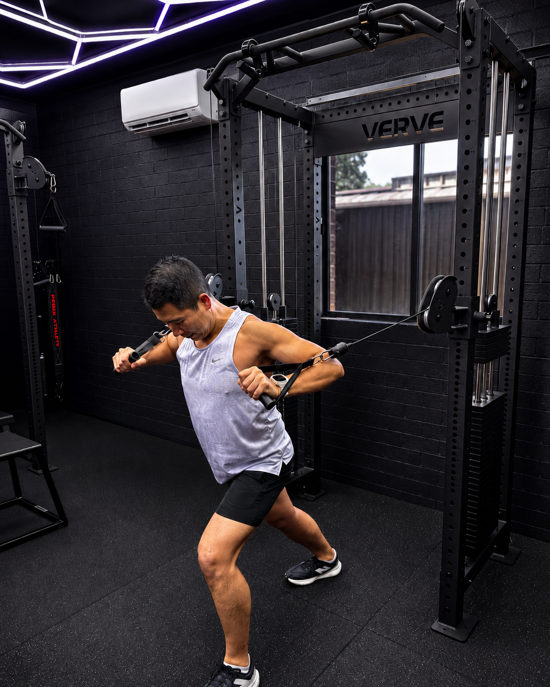 Elite Athletic member using a cable machine in Sydenham during a coached strength and conditioning session focused on technique, control and full-body strength.