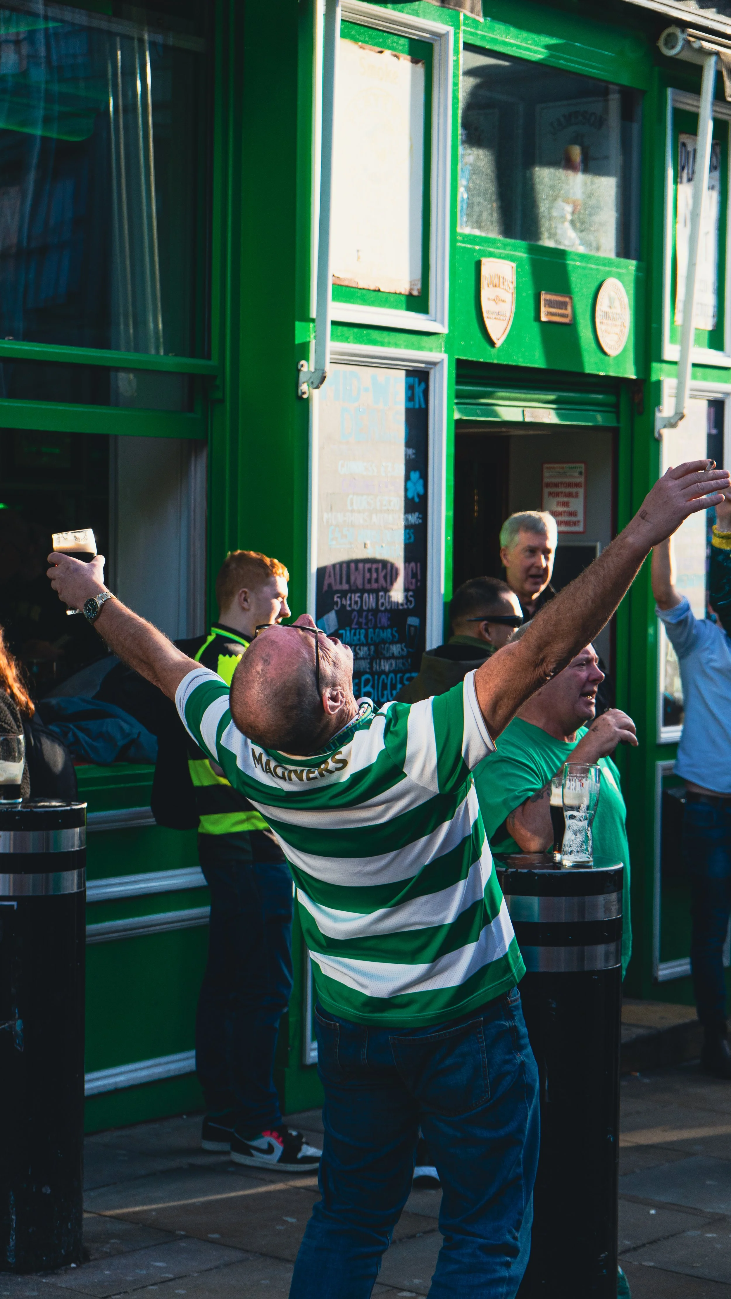 Celtic-fan-cheering-arms-up.jpg