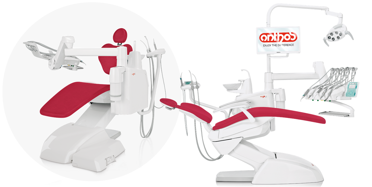 Modern dental clinic room with two dental chairs, one with a headrest and the other equipped with various dental tools and equipment, including a monitor and overhead light, all in white and red color scheme.