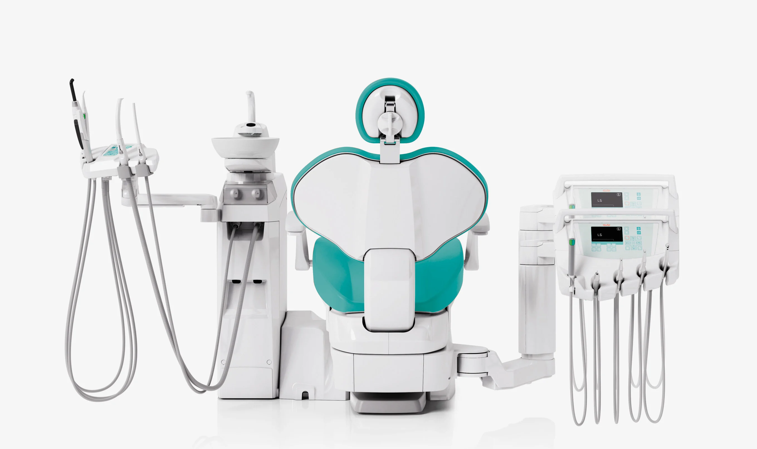 Dental office equipment including a dental chair, overhead light, and various dental tools on stands arranged for dental procedures.