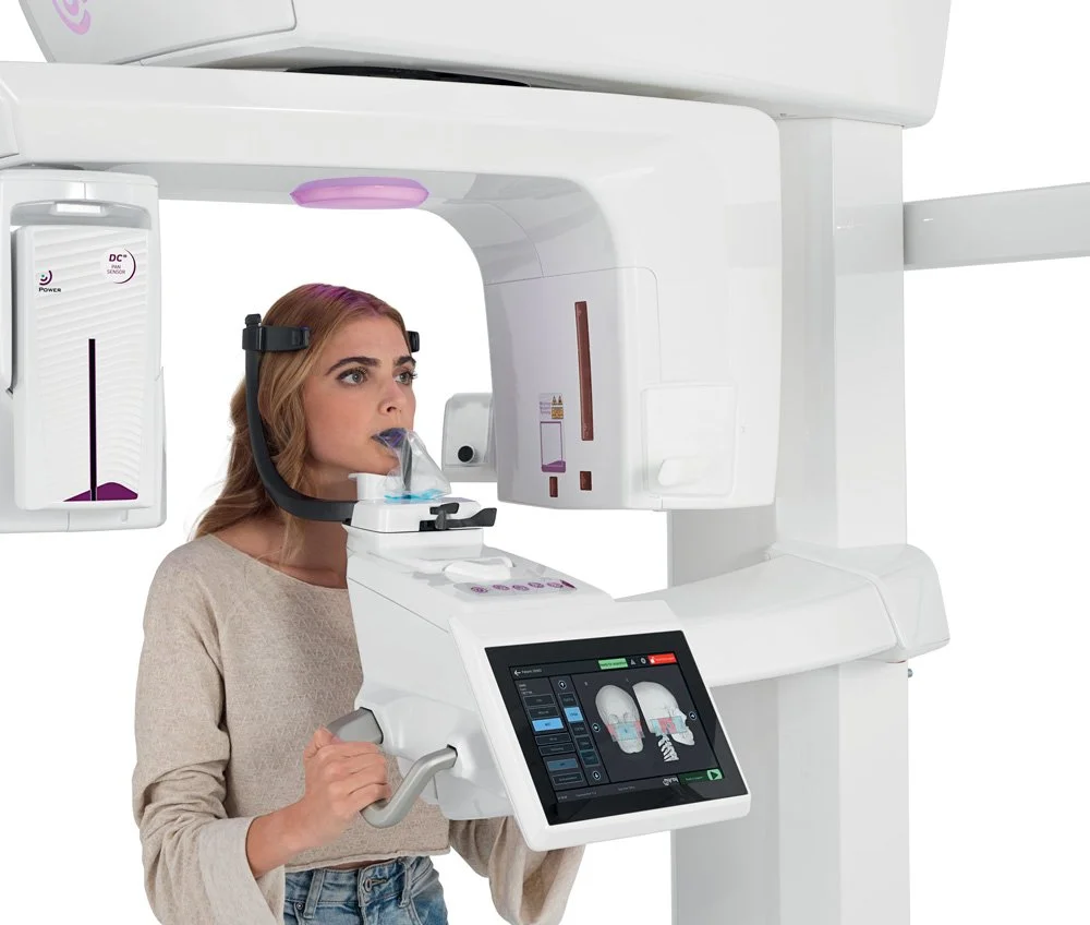 Woman undergoing a dental X-ray with a panoramic imaging machine.