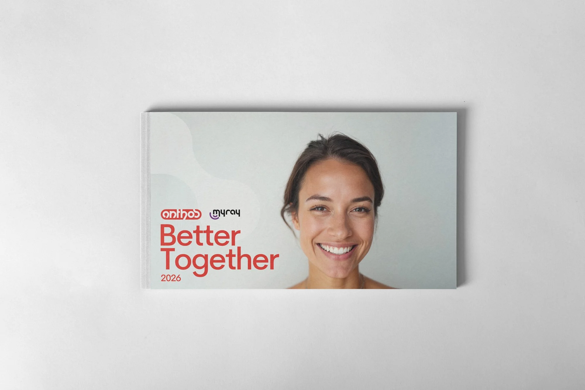 Cover of a 2026 calendar titled "Better Together" featuring a smiling woman with brown hair and brown eyes. The calendar is placed on a white surface.