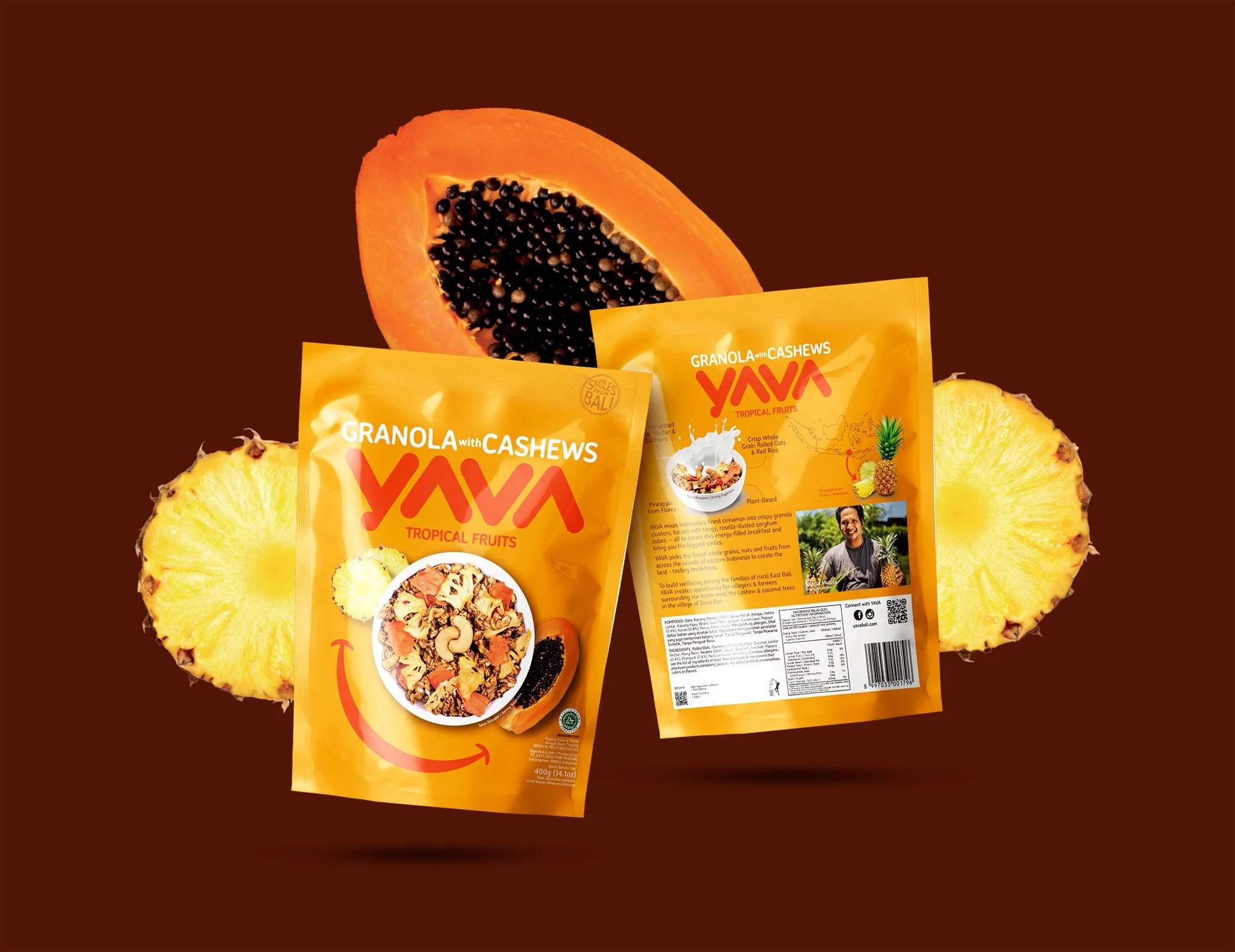 A yellow YAVA packaging pouch displayed with fresh papaya and pineapple slices against a dark brown background
