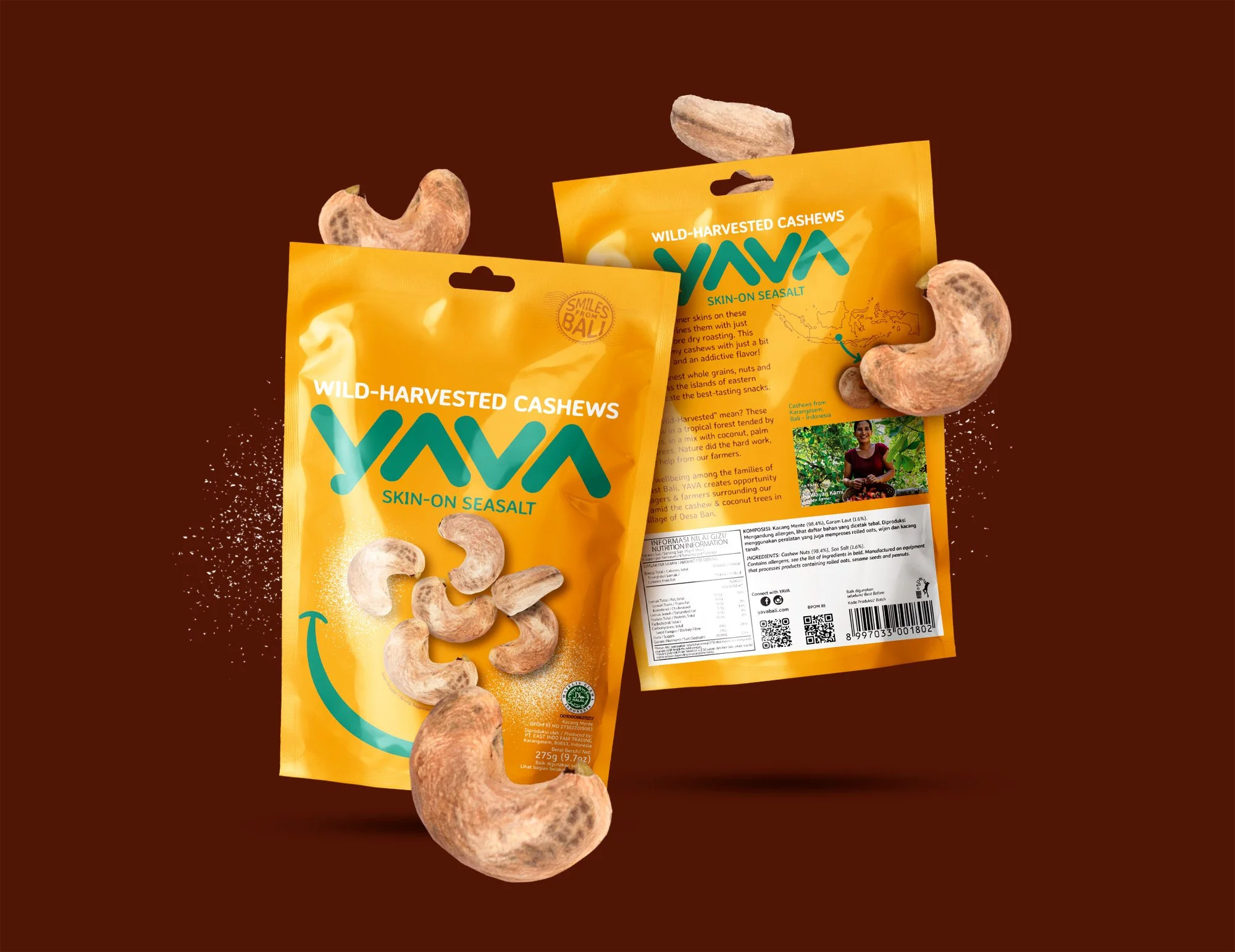 Two yellow YAVA Cashews snack packs with teal accent details shown with floating whole cashews