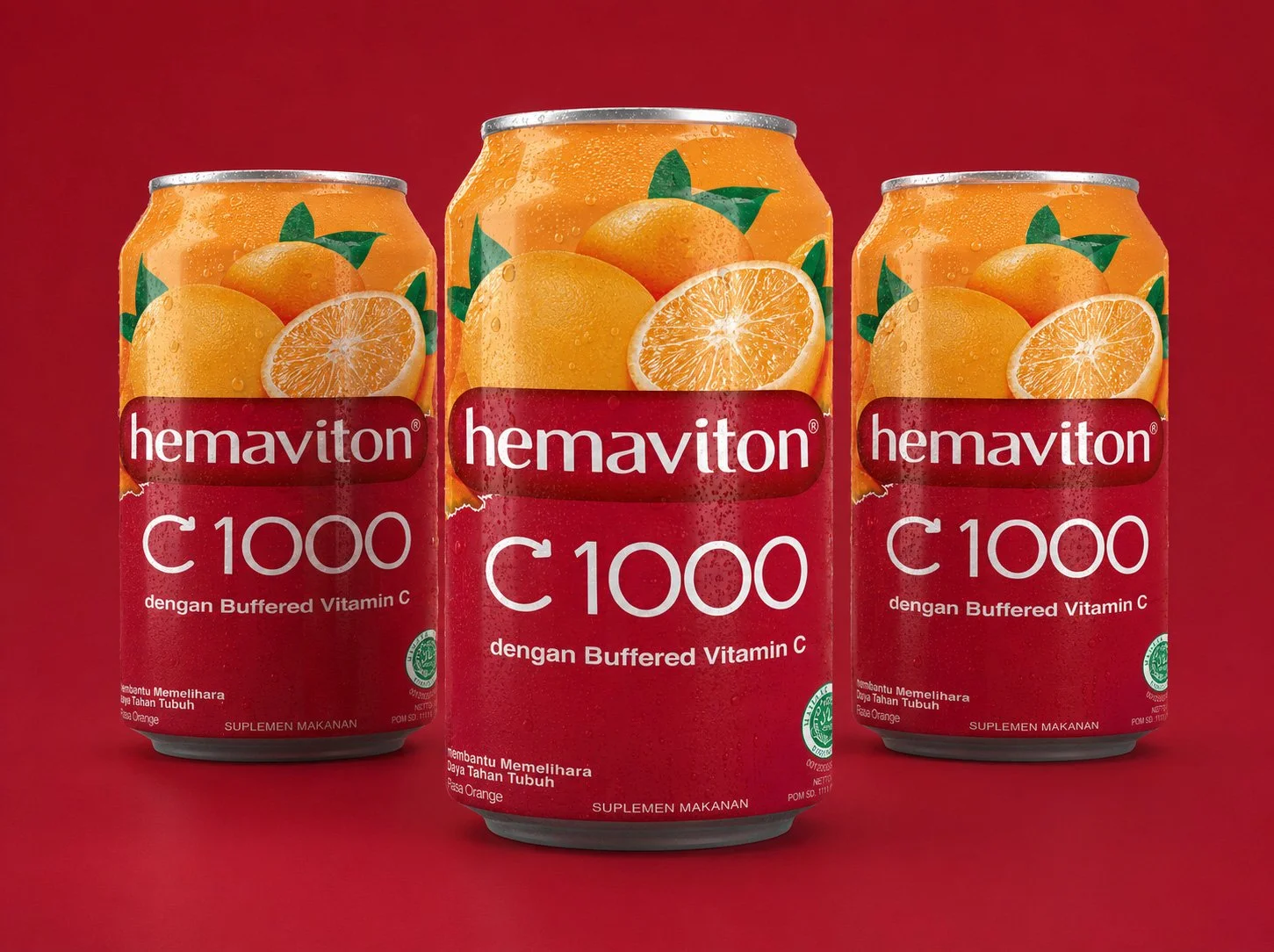 Three orange-flavored Hemaviton C1000 beverage cans with orange graphics set against a deep red background