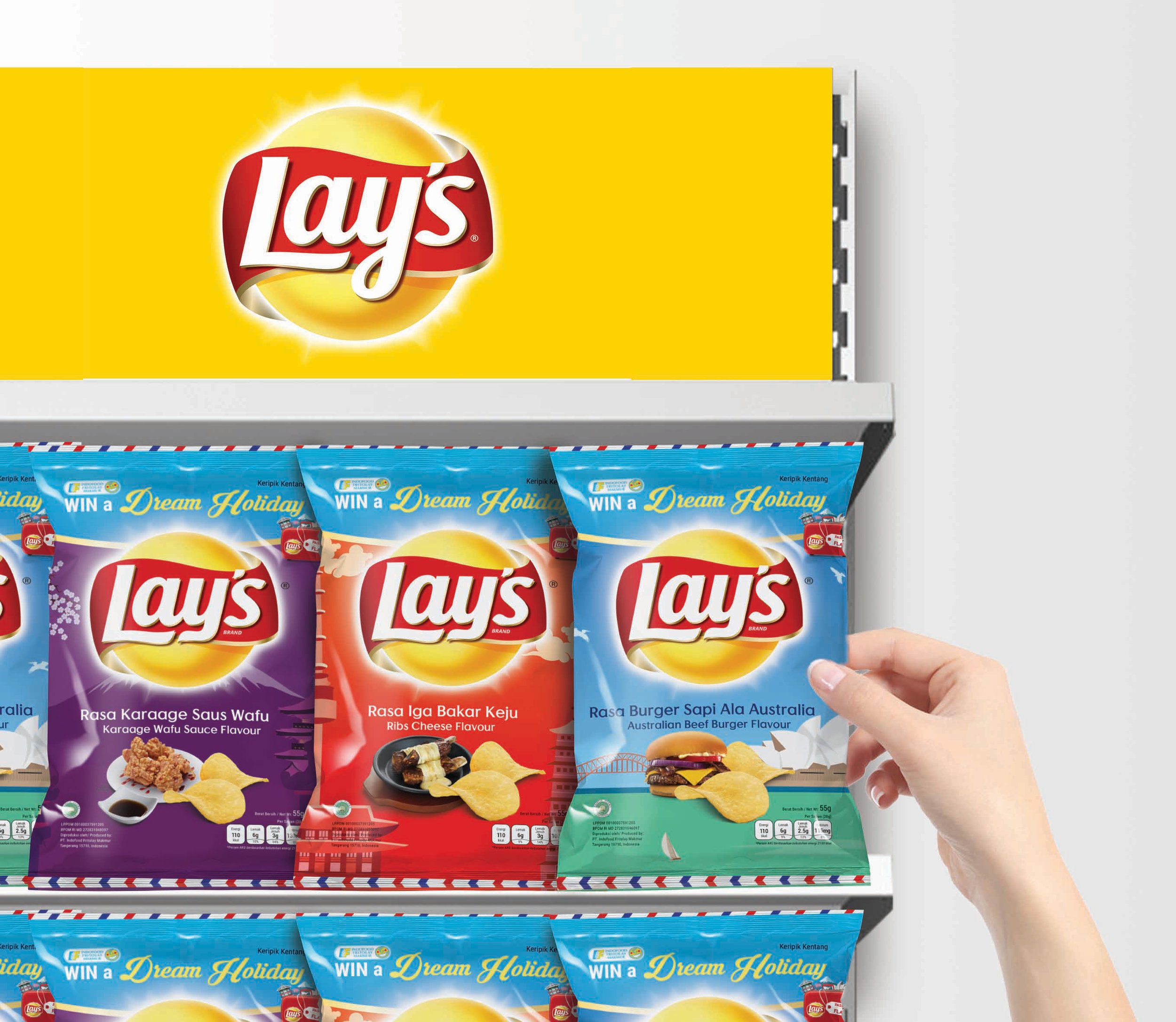 A retail store display shelf mockup filled with rows of colorful Lay's chip variants with a hand selecting a product