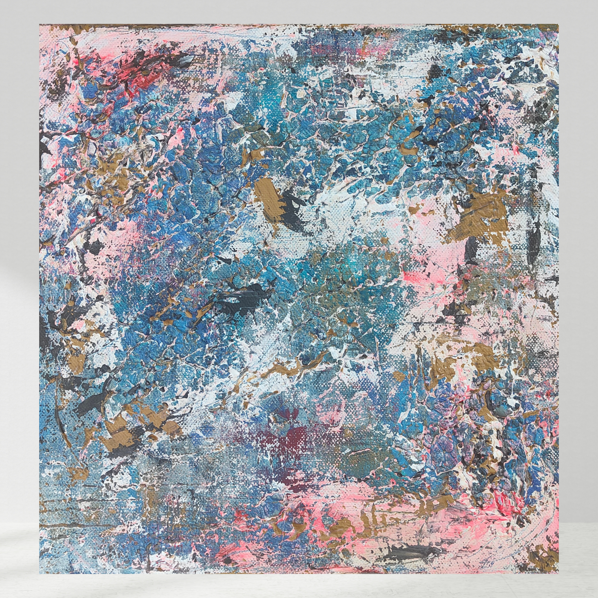 Abstract expressionist painting with pink, blue, white, black, and gold paint splatters and textured brushstrokes on a rectangular canvas.