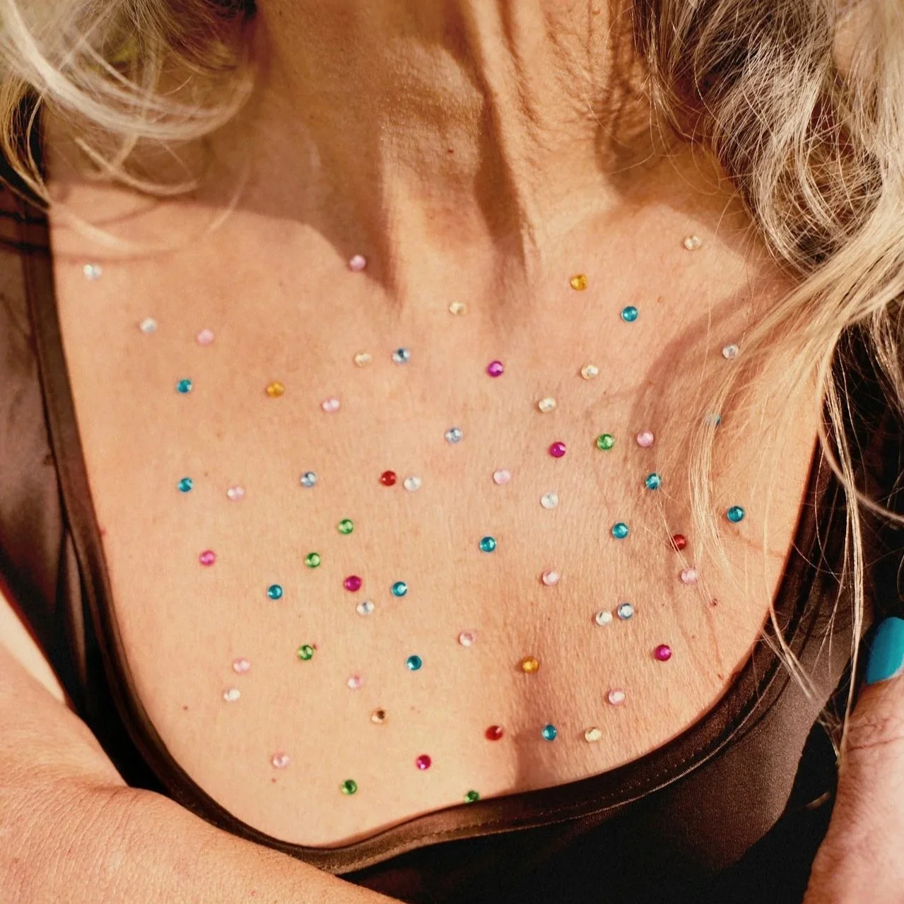 Lady with colour sparkles on her check