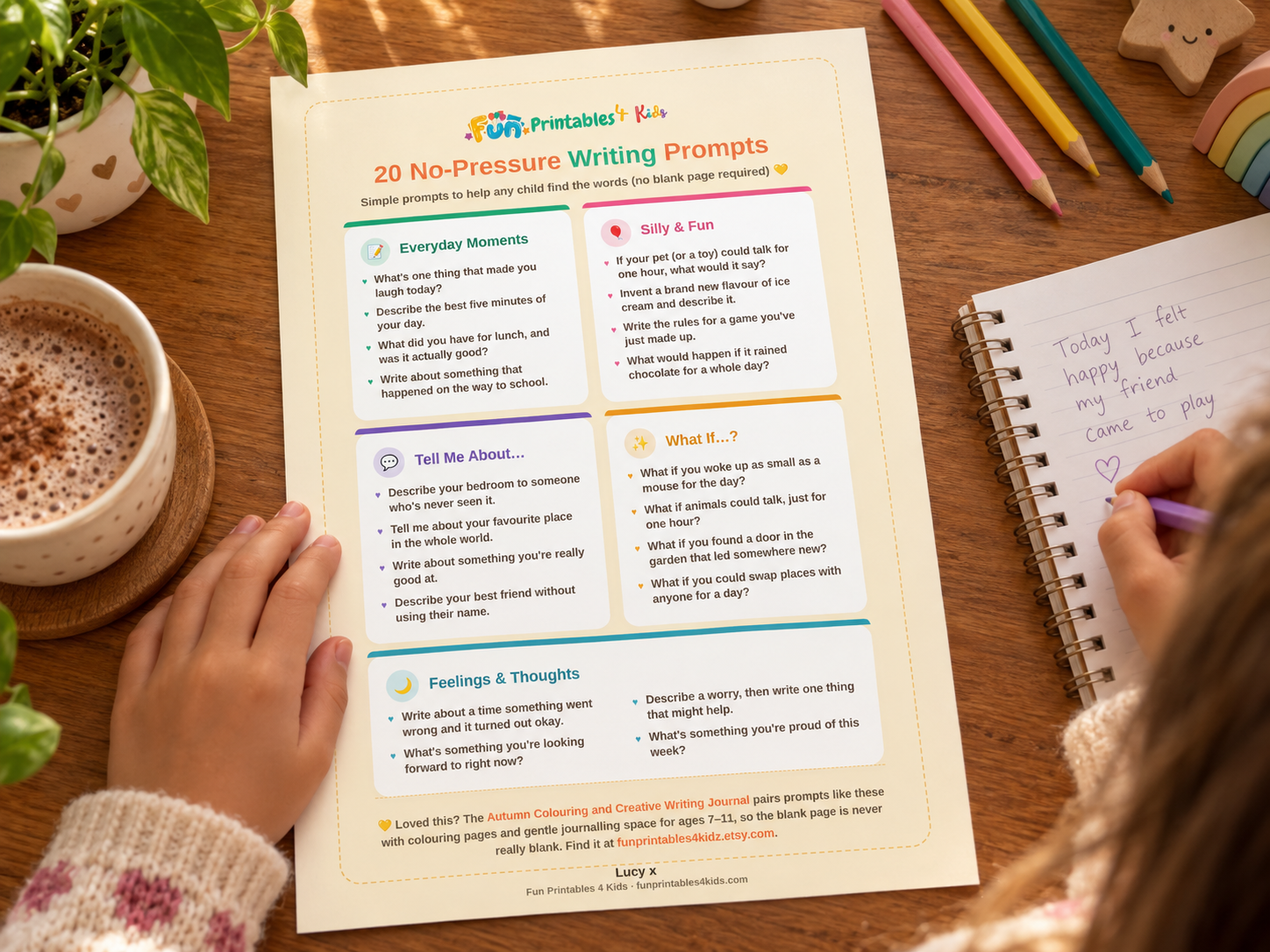 A child's hands can be seen on a warm wooden table holding a copy of the 20 No-pressure writing prompts freebie with a pencil in one hand and a notepad on the table.