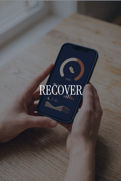Hand holding a smartphone displaying a recovery app with the word 'RECOVER' over the screen.