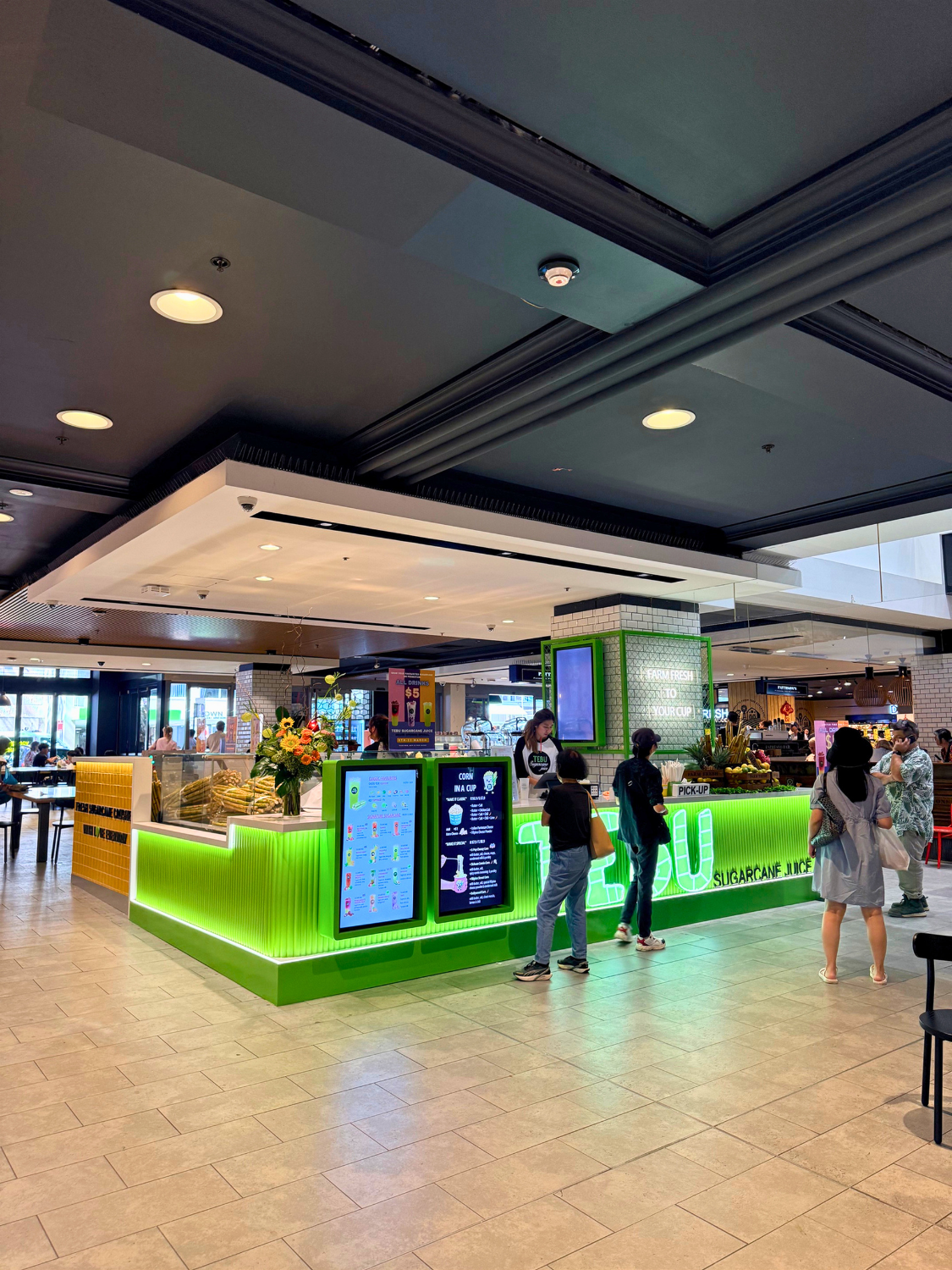 Tebu sugarcane juice kiosk serving customers inside a busy shopping centre