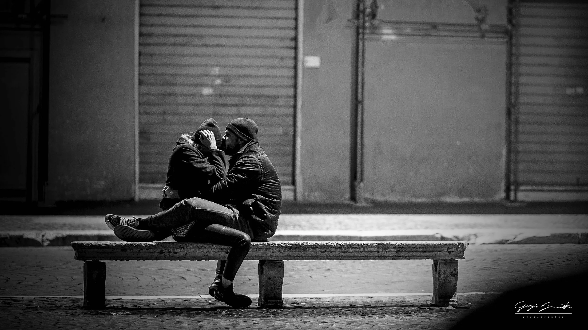 Rome — couple sharing intimate moment on urban bench, black and white — fine art street photography print by Hermes Gray, limited edition
