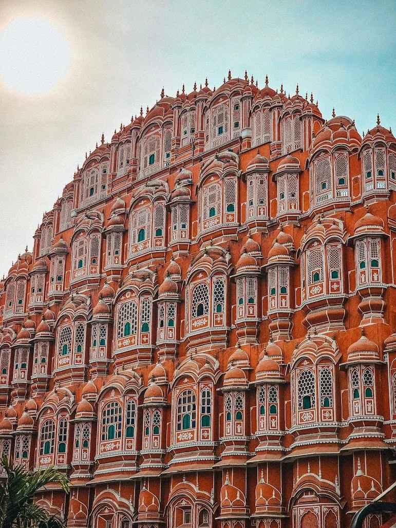 The intricate pink facade of the Hawa Mahal in Jaipur, a magnificent architectural stop on our fully-curated vegan tours through Rajasthan.