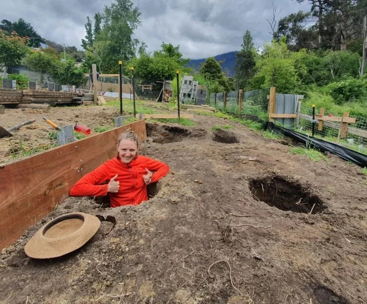 A participant of the Ground Up Wall Framing Course showing off a deep footing hole in preparation for pouring concrete and framing a garden shed