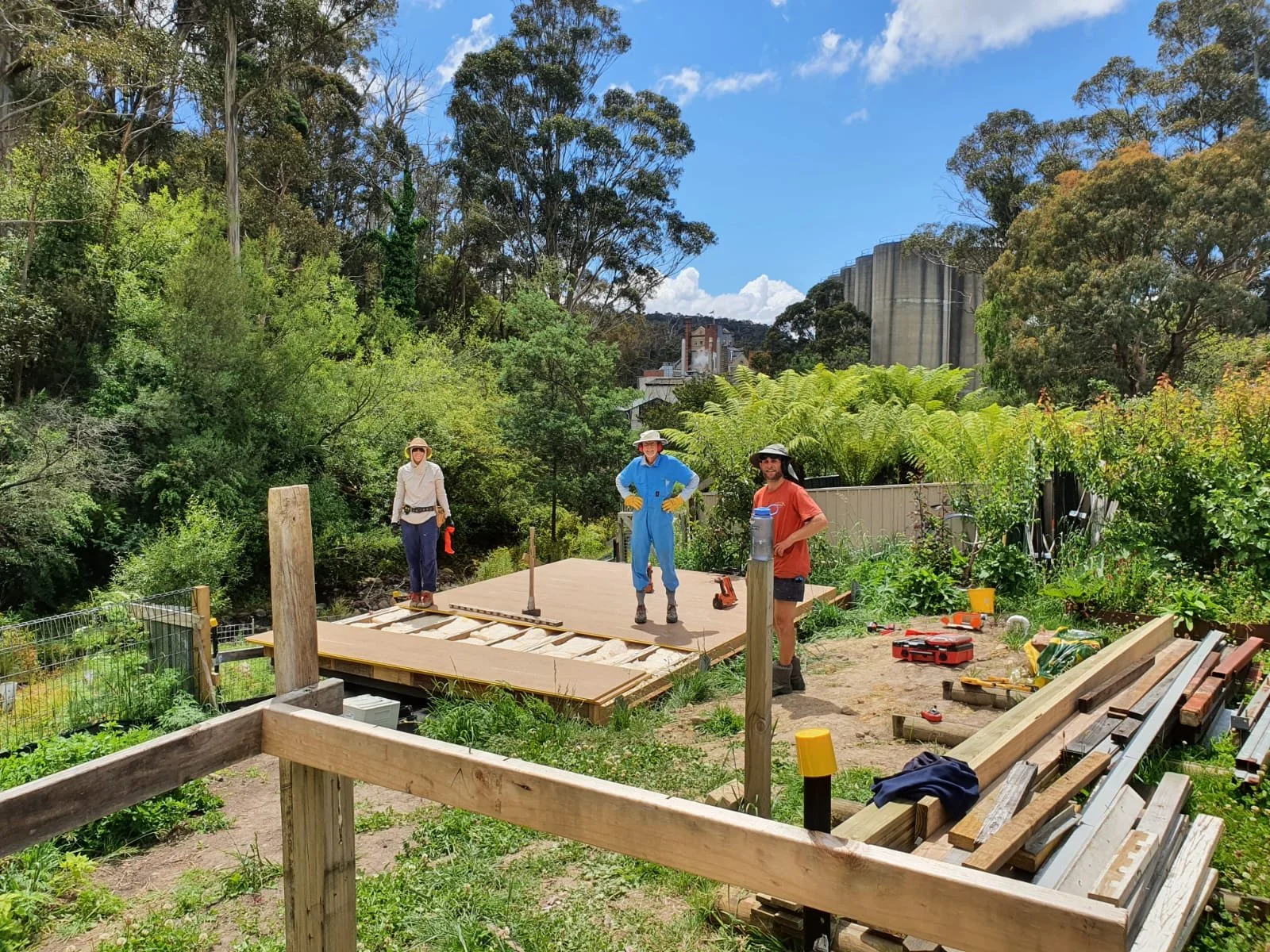 Adults of different ages learning practical carpentry skills together at Ground Up Workshops while building a full-size timber structure in Hobart.