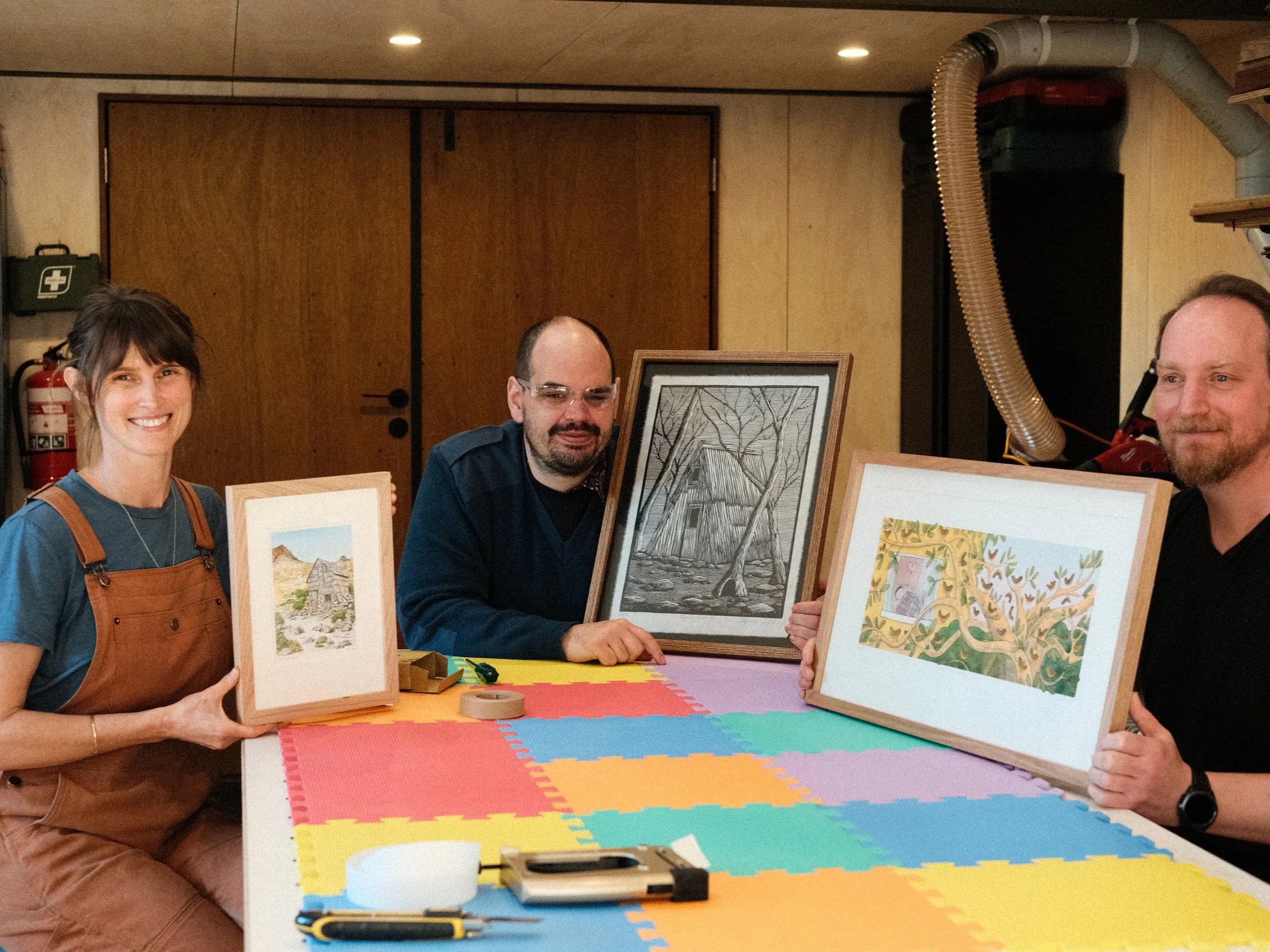 Students holding finished projects at Ground Up's weekend picture framing course