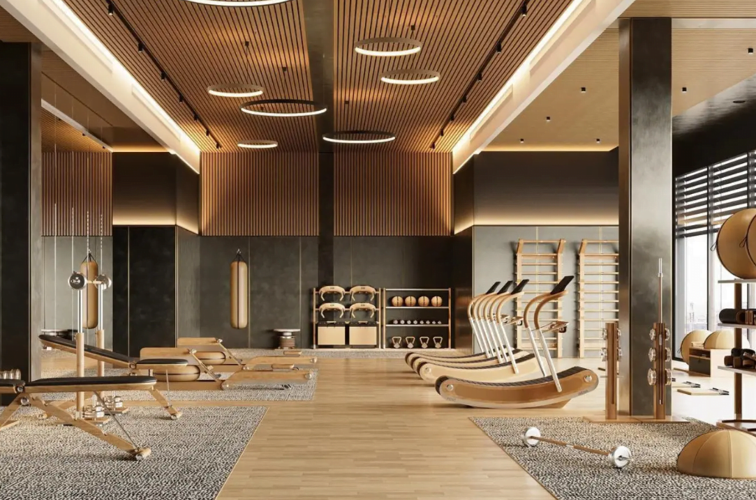 Modern gym with wooden equipment, workout machines, and natural lighting.