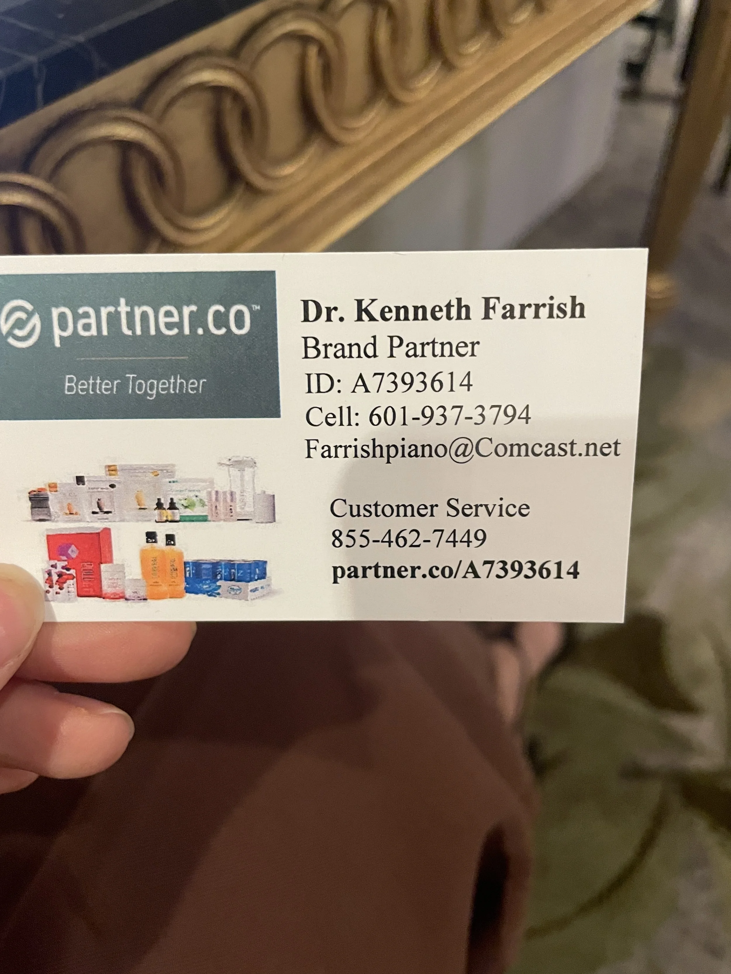 Business card for Dr. Kenneth Farrish, Brand Partner at partner.co, with contact information including phone number, email, and website, and a small image of various health and wellness products.