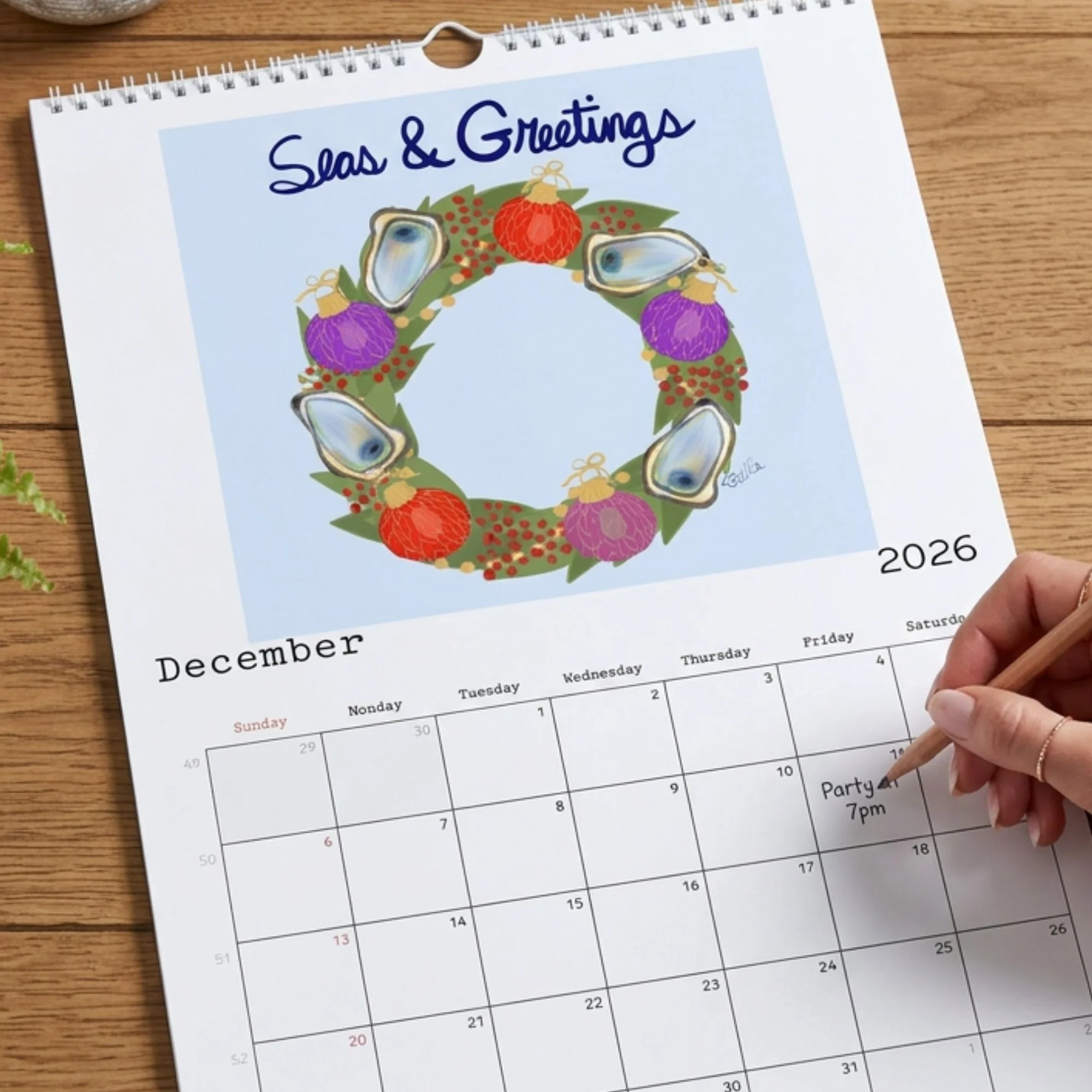 Seas & Greeting December calendar page on a wood table.jpg