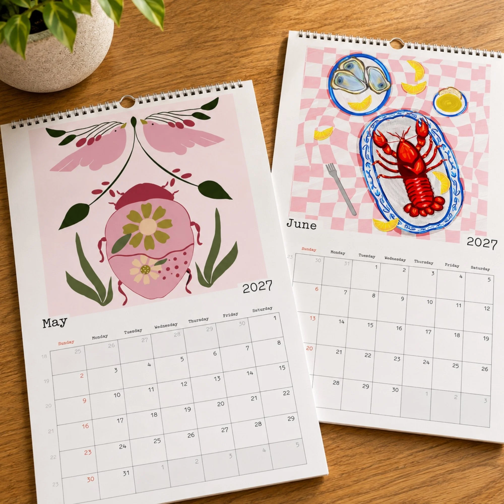 May and June calendars laying on wood table with house plant.jpg