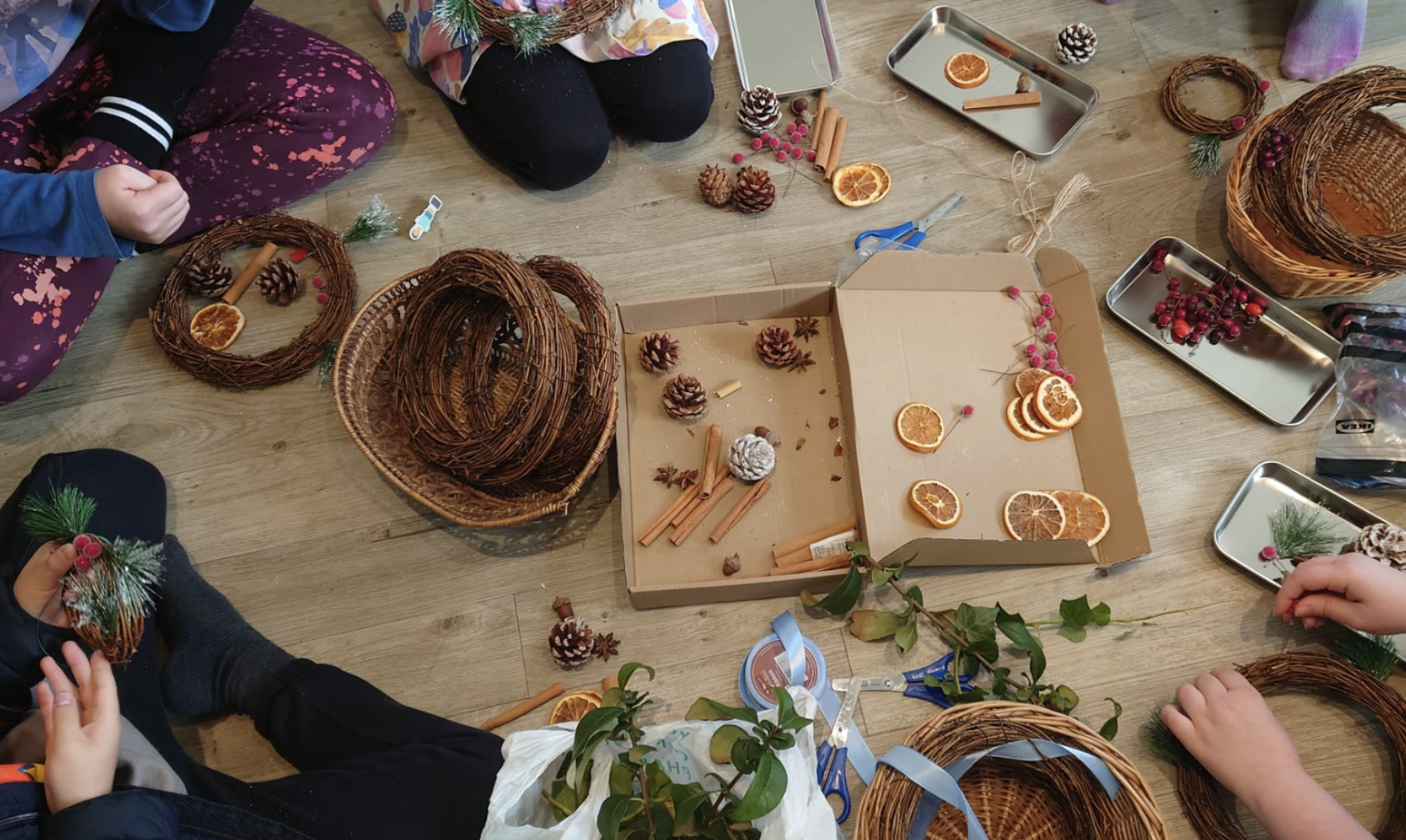 Children in a circle making wreaths