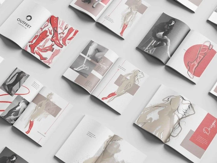Open magazines laid out on a white surface, featuring fashion photography and illustrations with women modeling outfits.